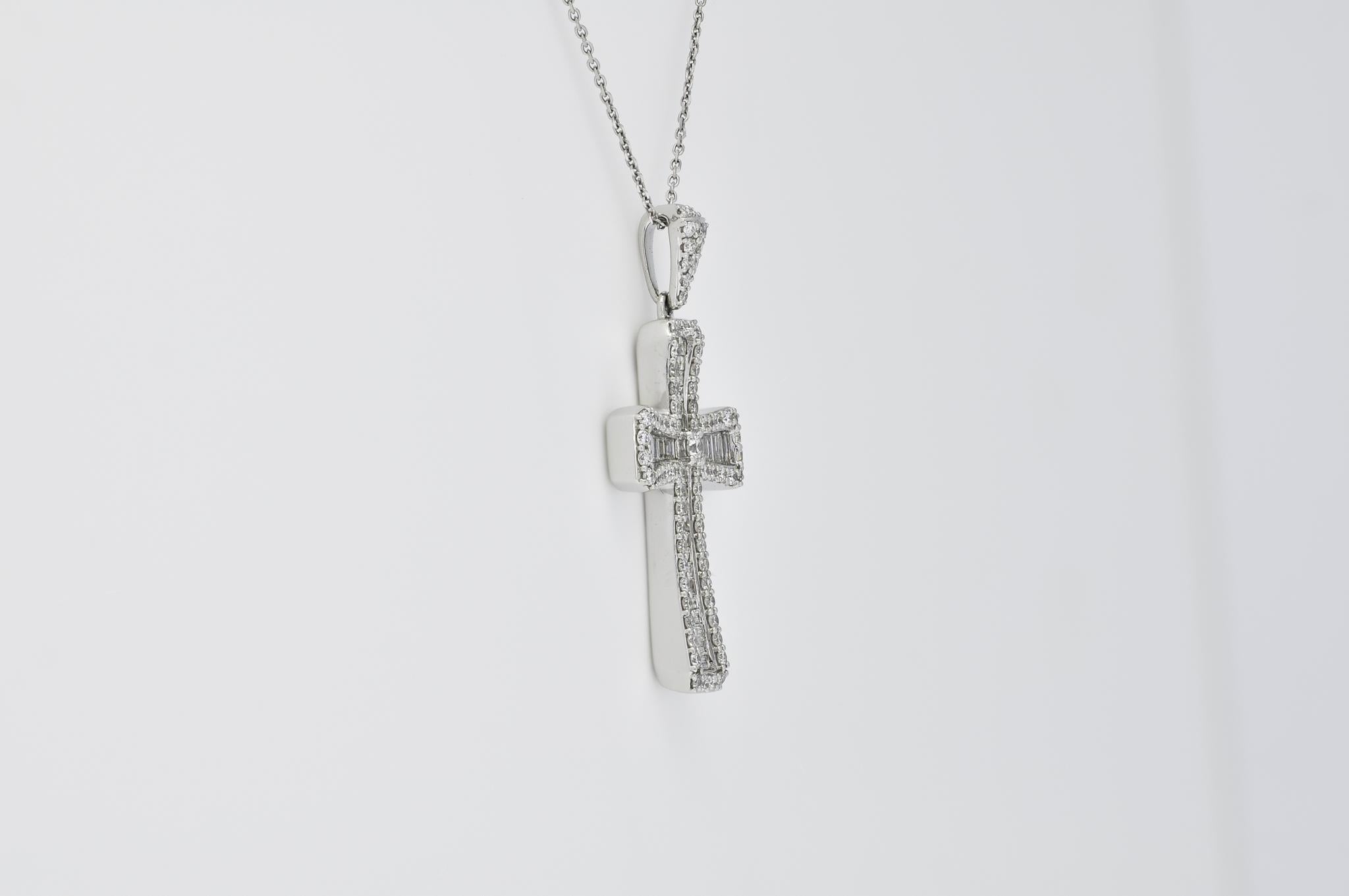 This Cross Pendant exudes a harmonious blend of celestial elegance and contemporary design. Crafted from gleaming 18-karat white gold, the pendant showcases a divine arrangement of natural diamonds totaling 1.42 carats. The juxtaposition of