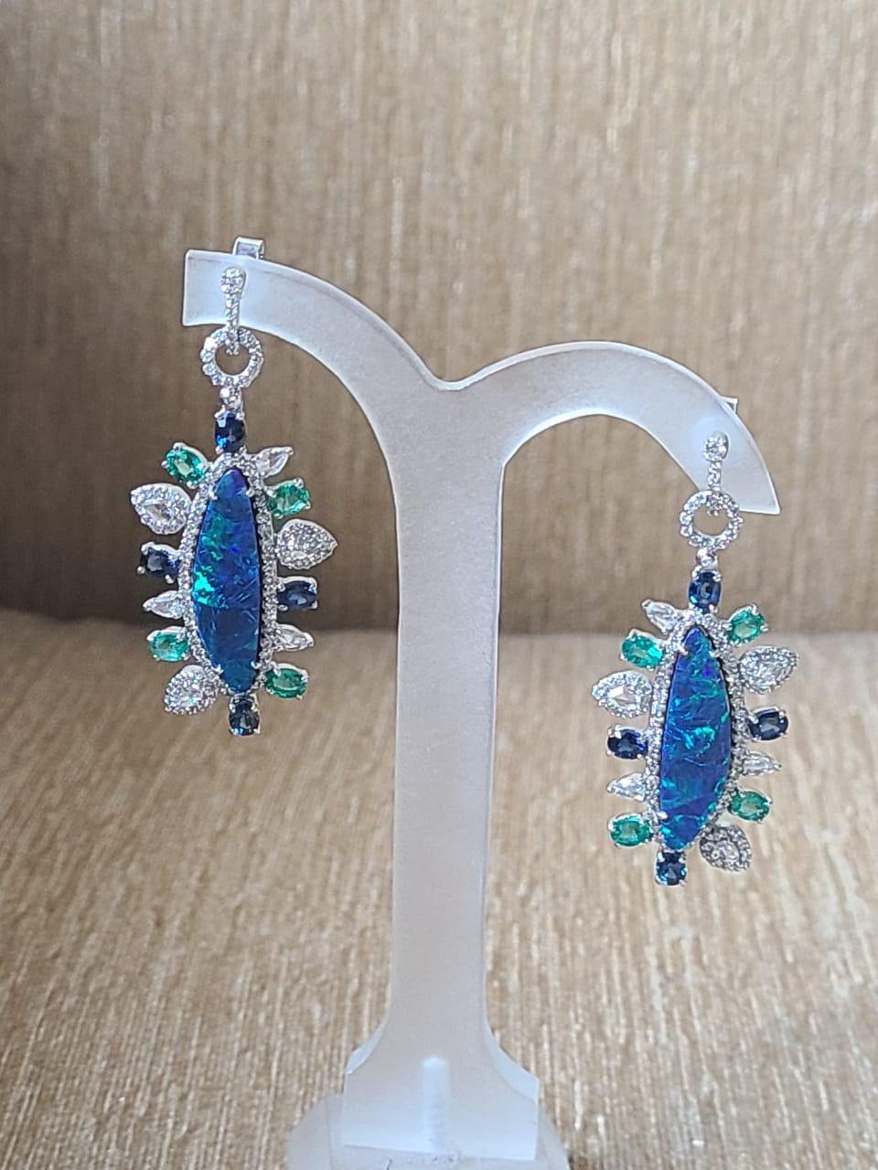 A very gorgeous and one of a kind doublet Opal, Blue Sapphire, Emerald Chandelier Earrings set in 18K Gold & Diamonds. The dimensions of the Earrings are 4.50cm x 2.00cm x 1.00cm (L x W x H). The earrings have a simple pull - push mechanism for