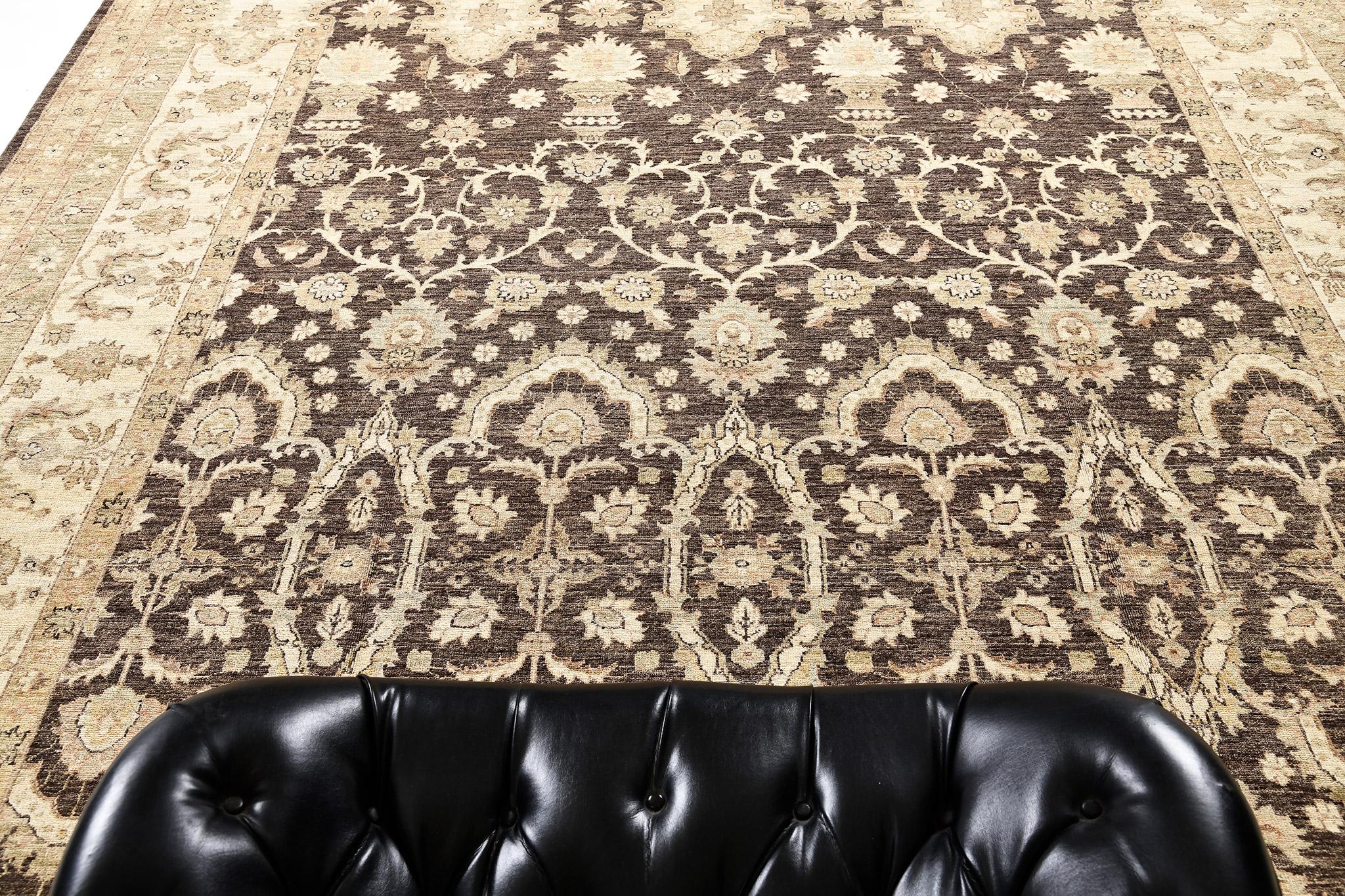 A gorgeous Amritsar design rug revival that features a dense, all-over arabesque, blooming palmettes, serrated leaves, leafy tendrils and amorphous botanical patterns. This exquisite rug is in the glorious shades of dark brown, sand and ivory which