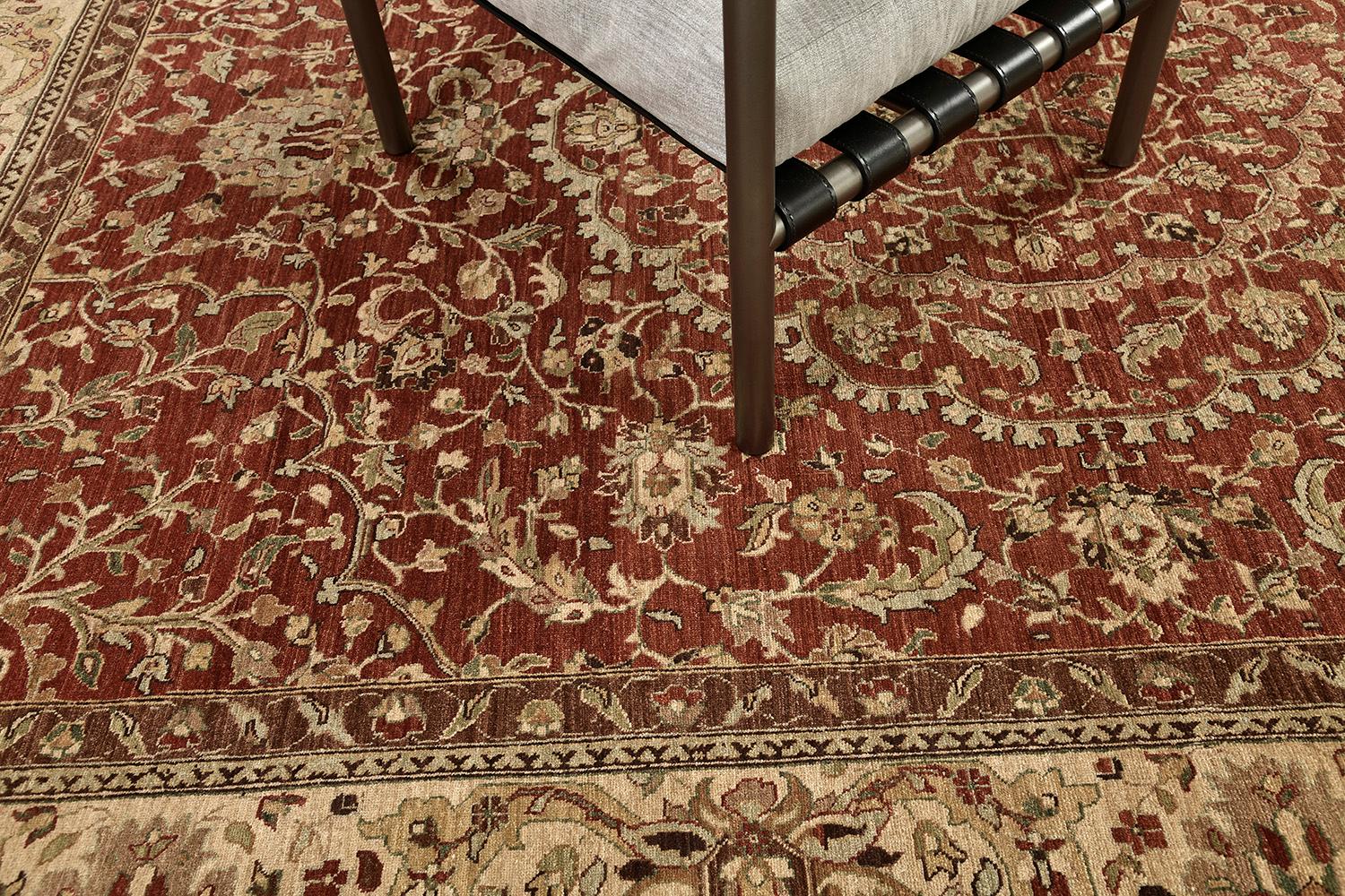 This luxurious hand-spun wool revival of Amritsar using a vegetable dye. Fashionable florid designs and leafy scrolls are harmoniously contributed to the surrounded symmetrical florets and vines. The rug dominants a dusty red field, a sand border
