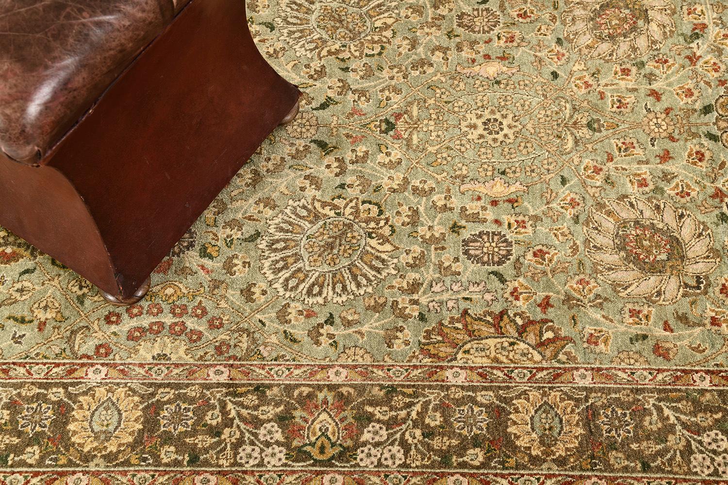 A phenomenal Hadji Jalili's Tabriz Runner has supremely incorporated the lovely all-over blooming scrolls and traditional Persian designs in an ash green field that keeps the pattern very extraordinary and intricate. Borders are symmetrically