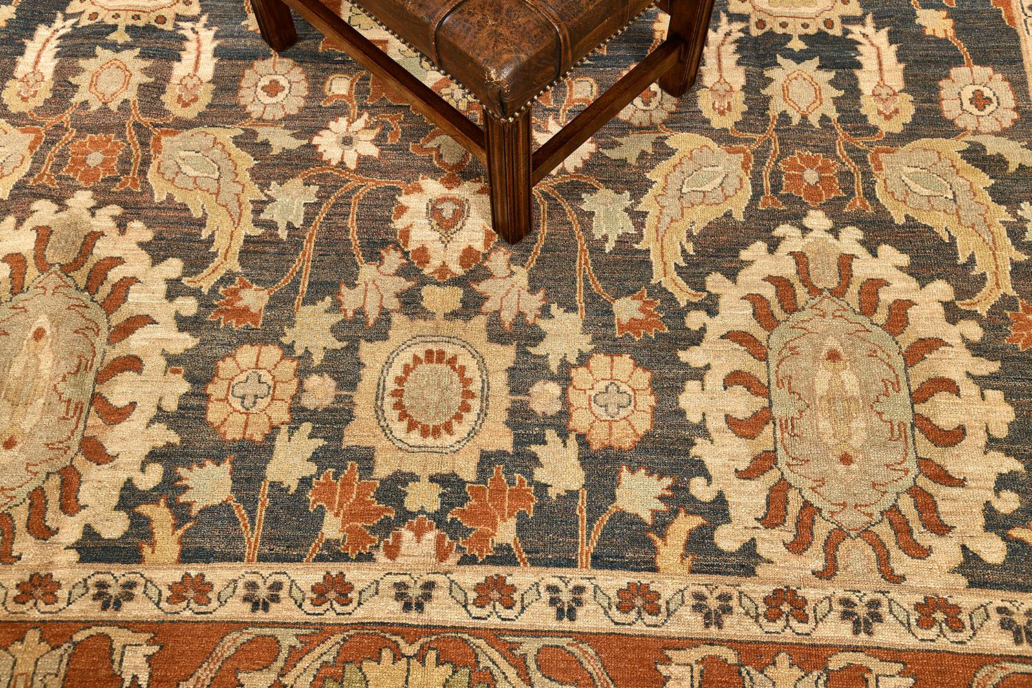 This elegant and timeless Sultanabad rug made from vegetable dye has an intricate symmetric pattern and has clear grandiose medallions all over the design. The details of these patterns are perfectly spun in midnight blue field terracotta borders