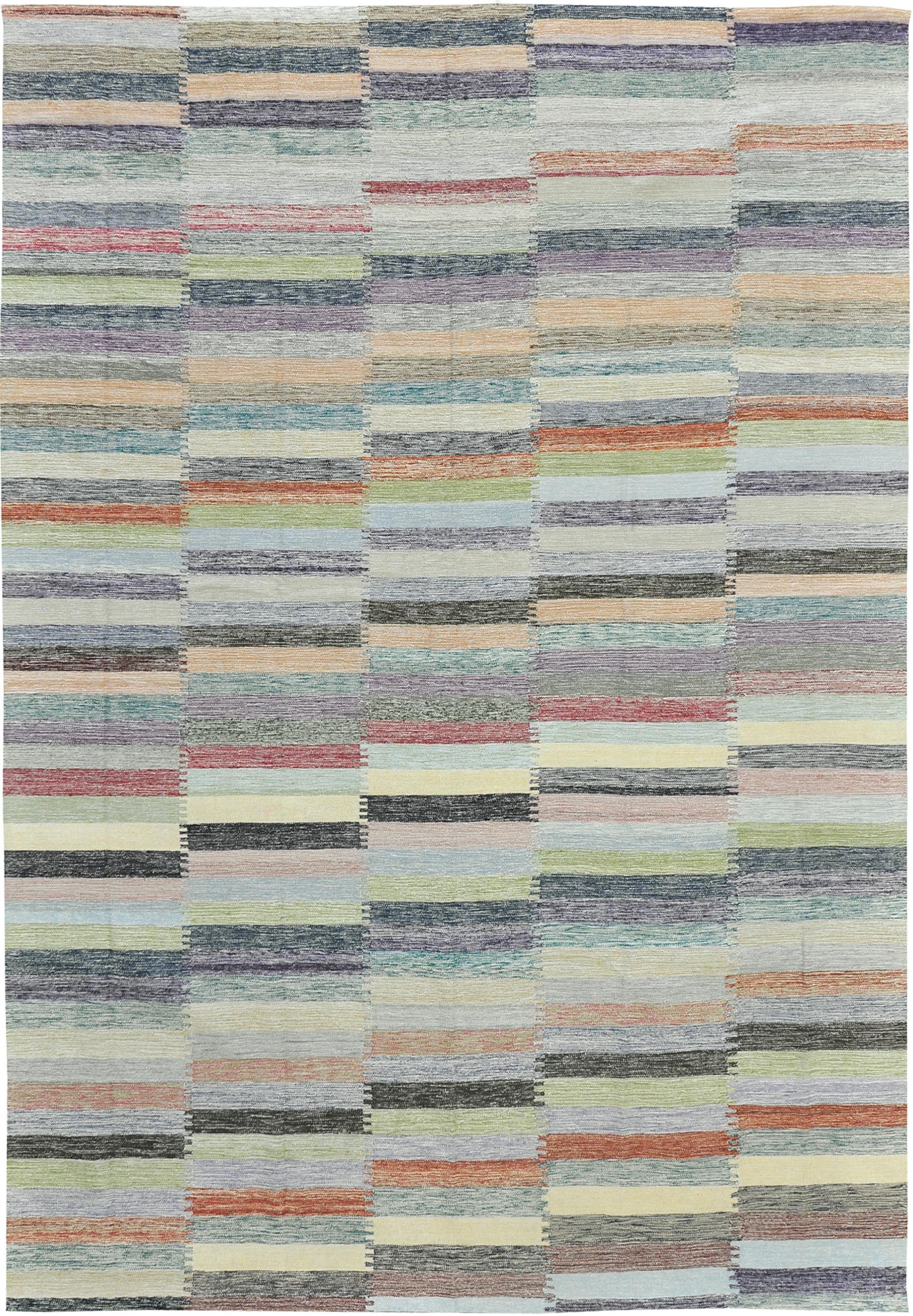 A colorful flat-weave Kilim from our Puro Collection. This multicolored design uses color blocking to create a rectangular brick-like effect. The Puro Collection features contemporary designs handmade by skilled artisans in Pakistan. This flat weave