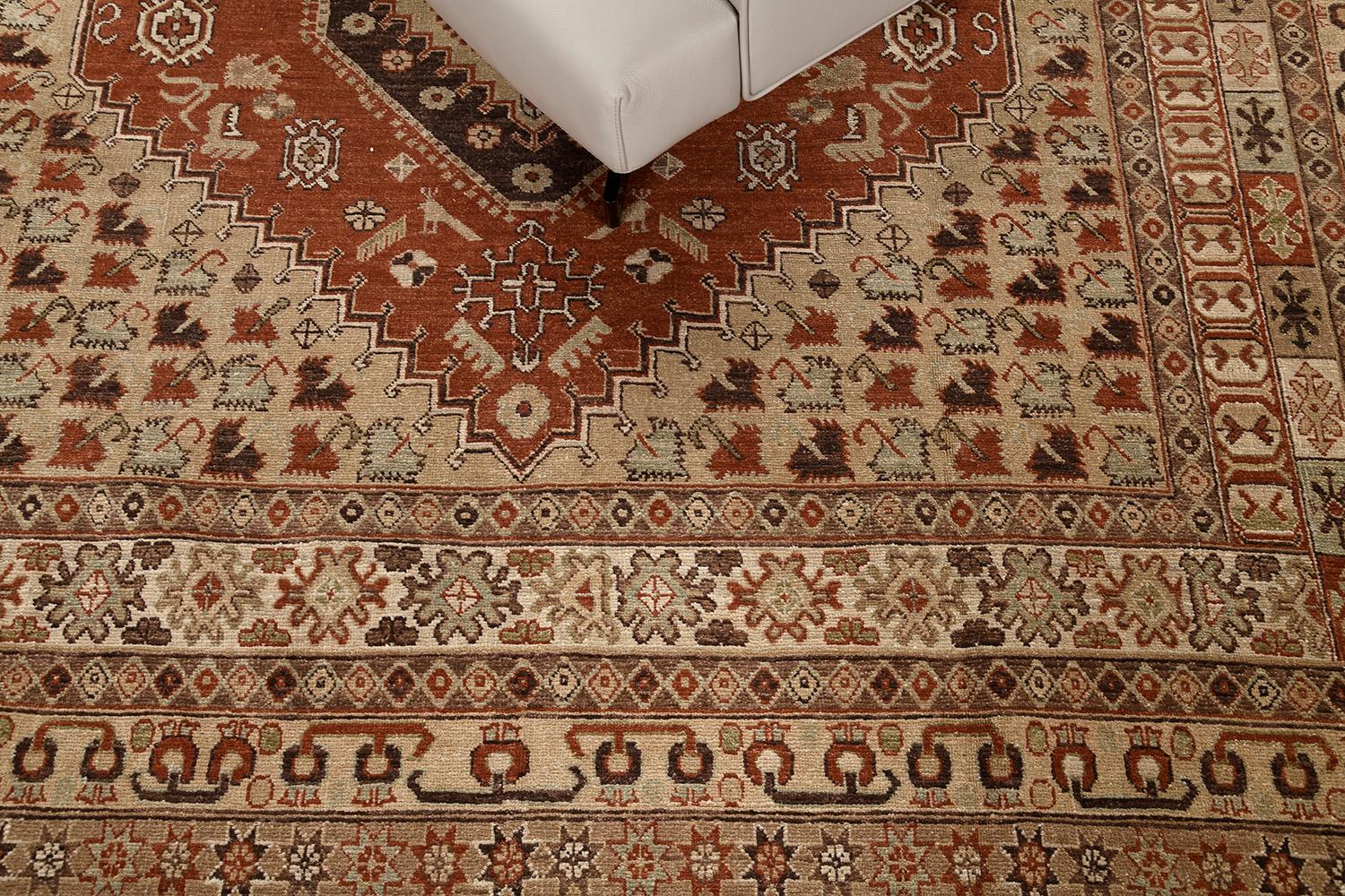 A stylishly luxurious hand-spun wool Gashgai Style Rug has immensely flexed its series of the band along the perimeter of emblems. It is surrounded by different kinds of intricate symbols and geometric motifs. The neutral color scheme is perfect for