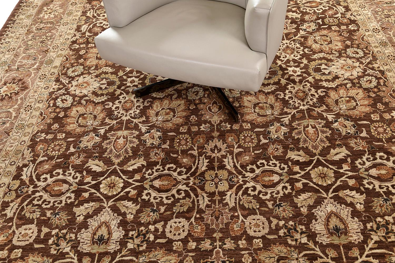An elegant revival of Hadji Jalili has a neutral ground with sand and tan motifs that are accentuated with walnut-colored outlines. An all-over pattern that has finely rendered motifs of branching vines, palmettes, and leaf and floral clusters.