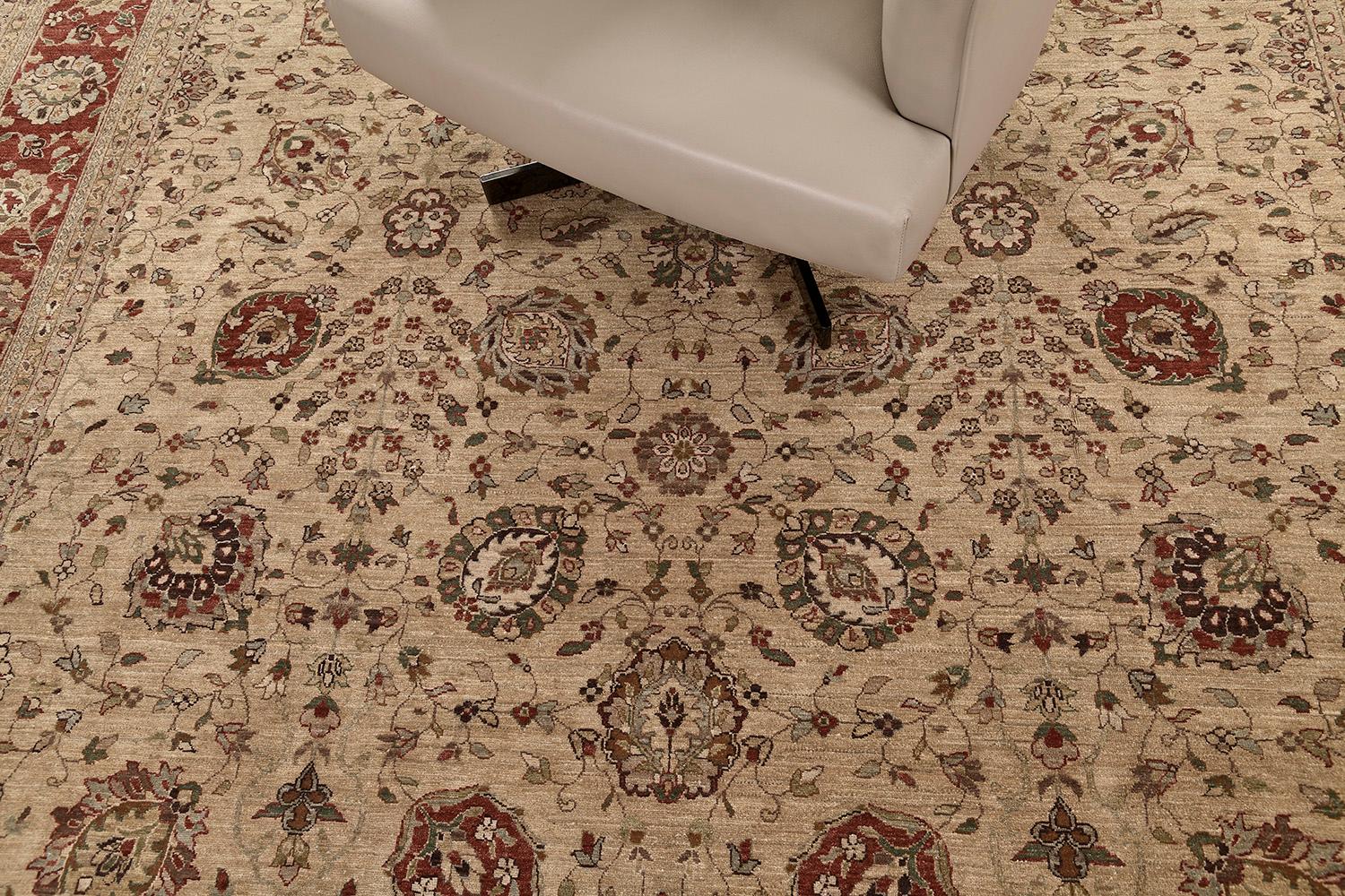 An exceptional Hadji Jalili's Tabriz rug has supremely incorporated the lovely all-over blooming scrolls and traditional Persian designs in an oatmeal field that keeps the pattern very extraordinary. Borders are symmetrically designed which makes