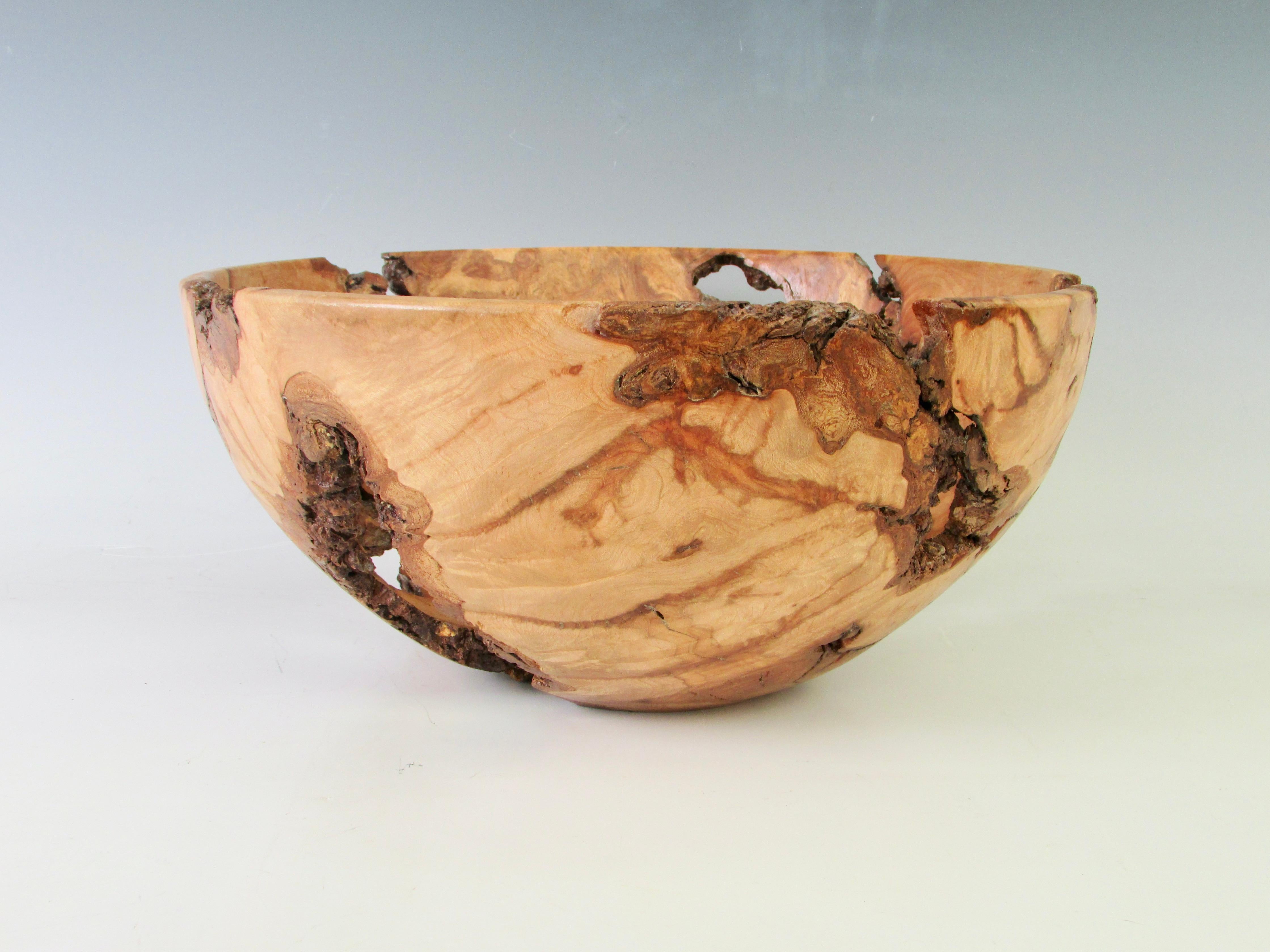 Nicely turned burl wood bowl. Turning and sculpting done in a way to highlite the natural inclusions of the burl and bring out the beauty of the organic form.