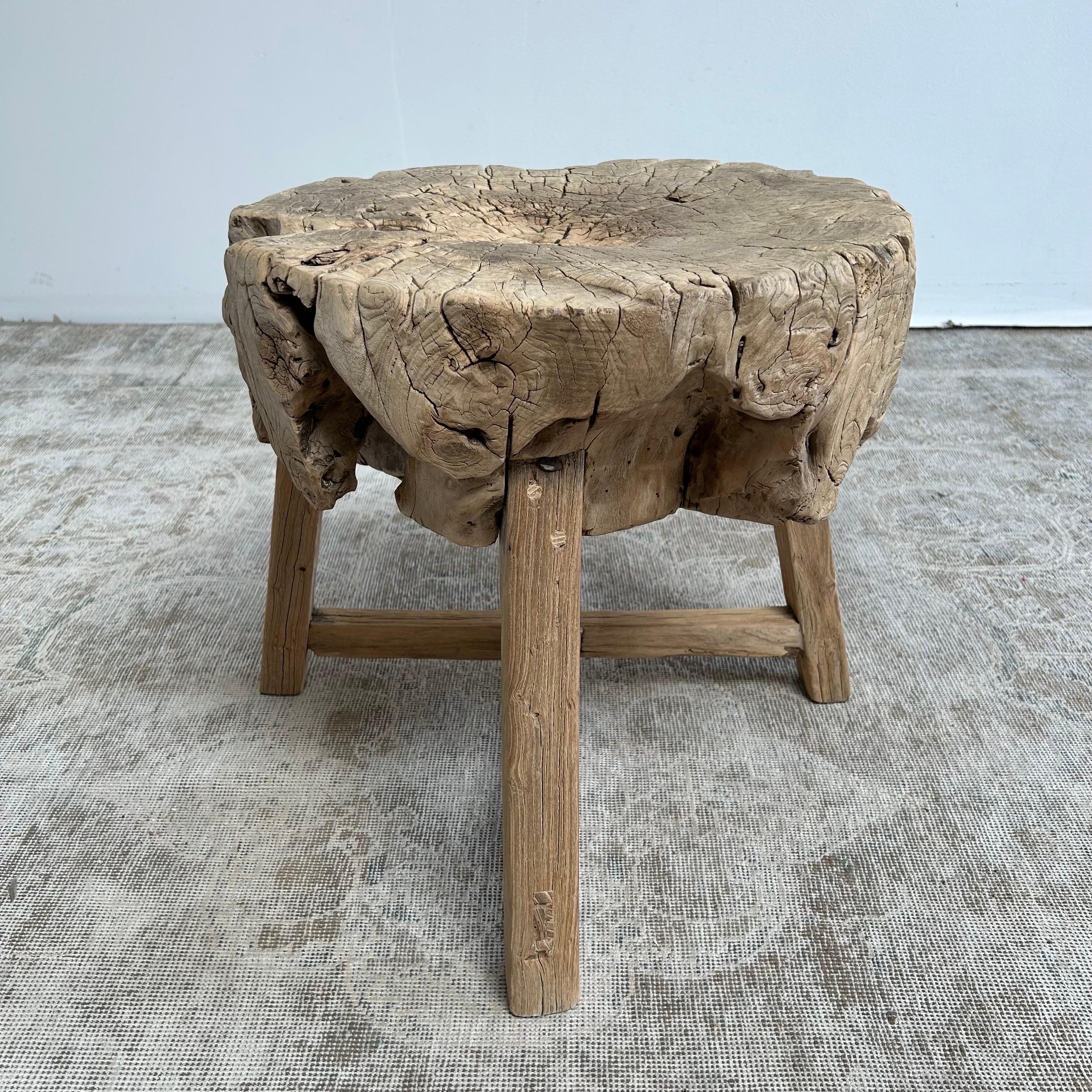 Elm wood stump slice or chop block table.
This solid stump slice was turned into a side table or stool. The solid thick top has a beautiful movement with unique characteristics. A natural live edge to show shape and form of what was. Solid and
