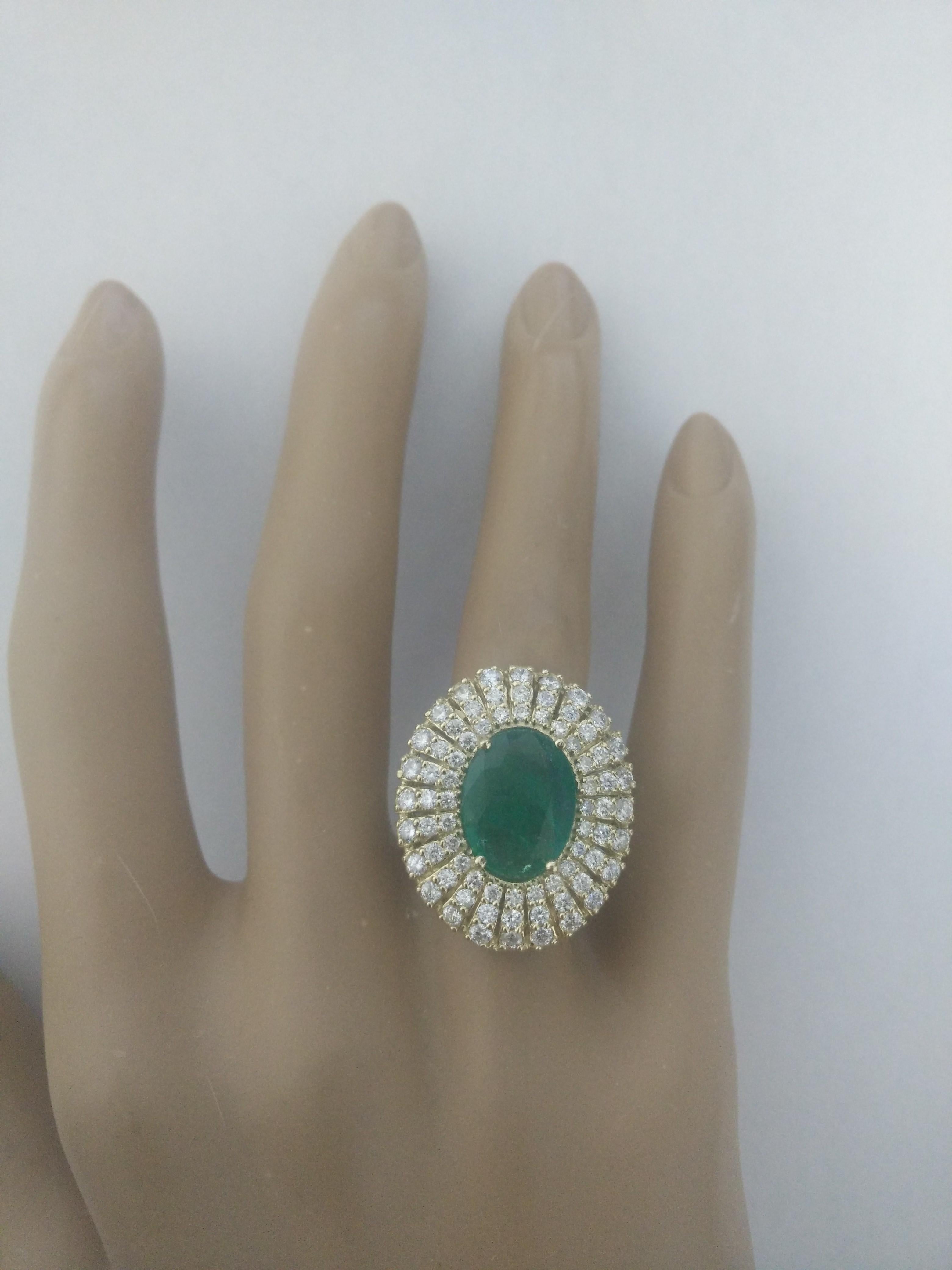 6.94 Carat Natural Emerald 14 Karat Solid Yellow Gold Diamond Ring
Stamped: 14K
Total Ring Weight: 6.5 Grams 
Emerald Weight: 5.34 Carat (12.00x10.00 Millimeters)  
Diamond Weight: 1.60 Carat (F-G Color, VS2-SI1 Clarity )
Face Measures: 25.25x21.75