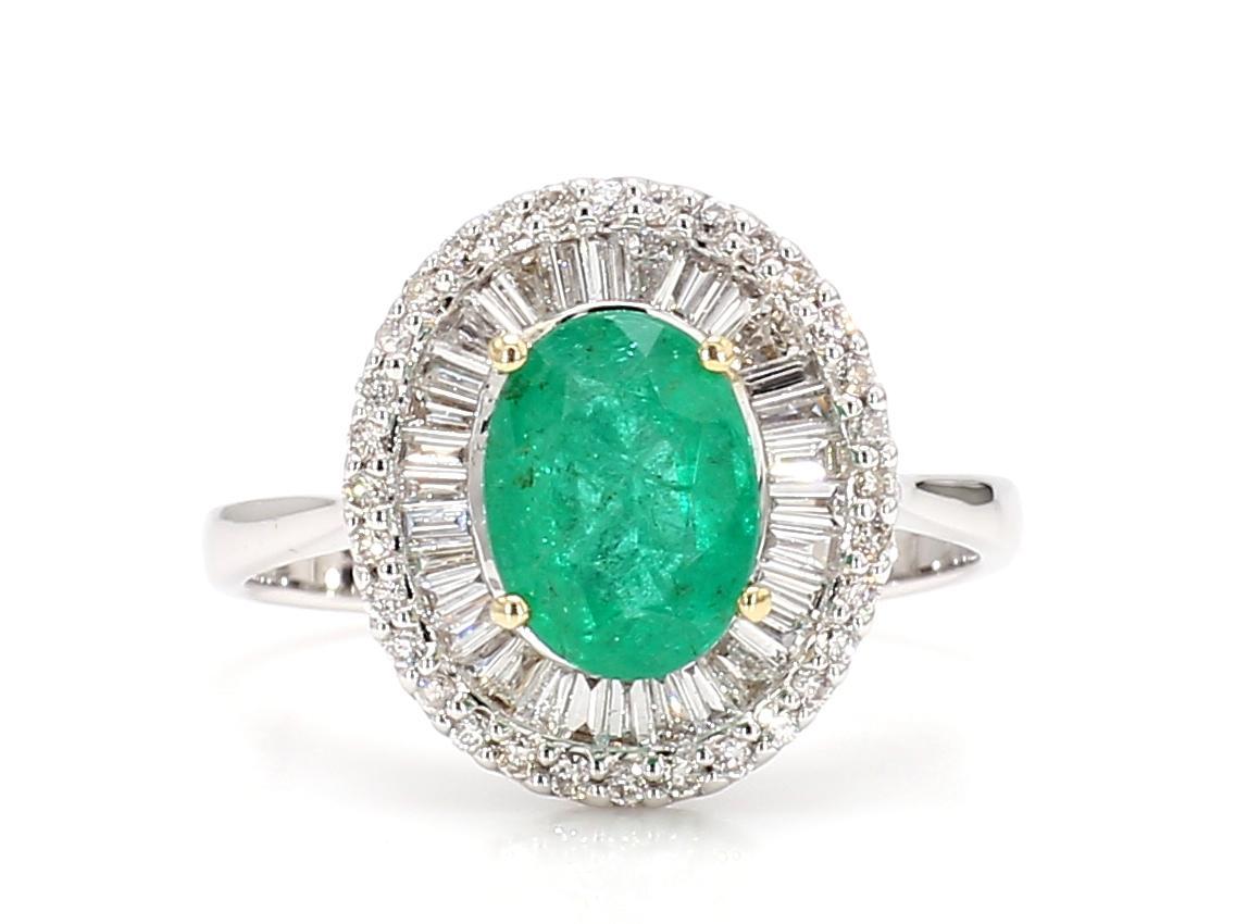 Discover refined elegance with our exquisite Emerald Diamond Halo Ring. This captivating piece showcases a 0.9 carat oval emerald, celebrated for its vibrant green hue and enchanting presence. The emerald, set as the centerpiece, draws the eye with