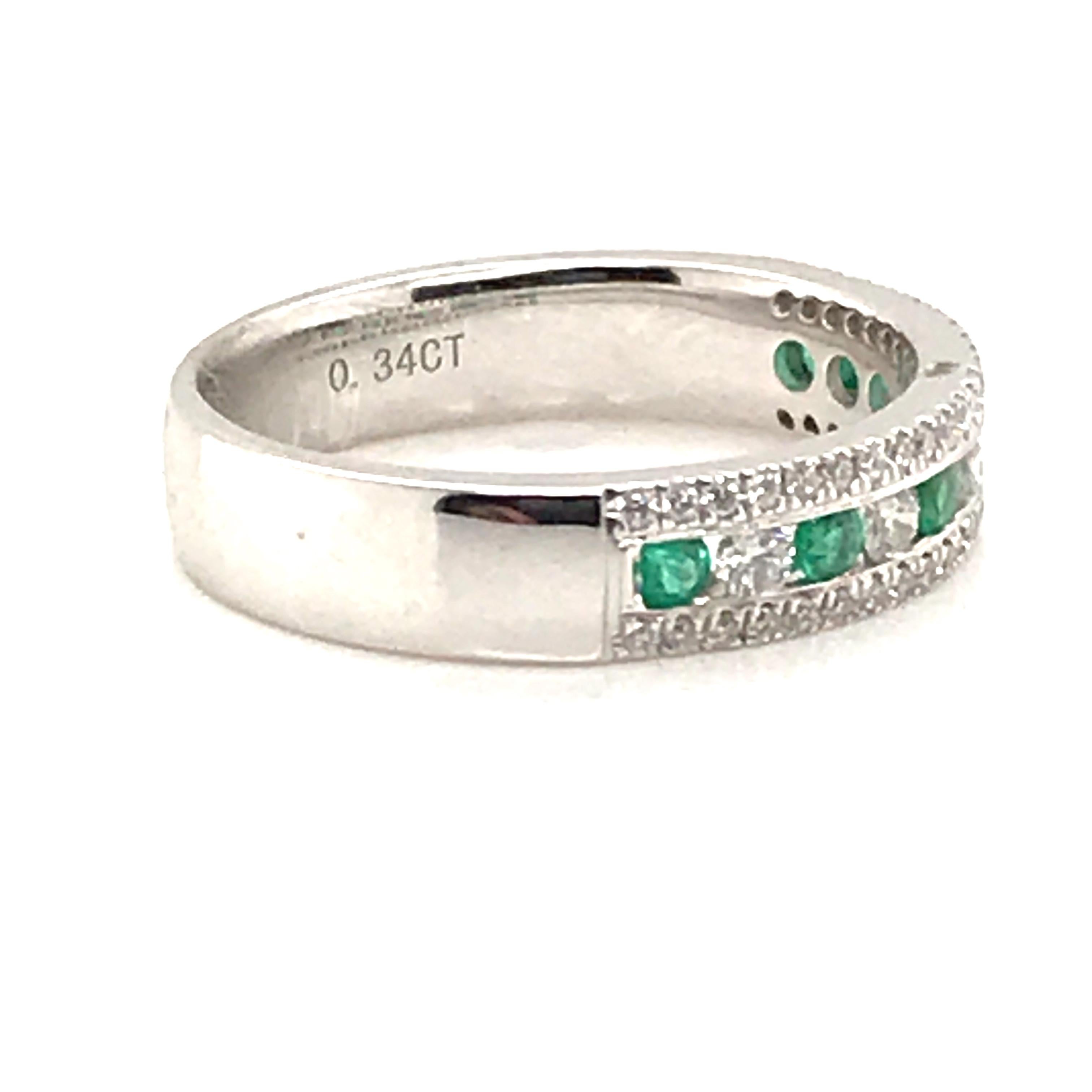 HJN Inc. Ring featuring a Natural Emerald and Diamond Channel Band

Emerald Weight: 0.18 Carats 
Round-Cut Diamond Weight: 0.34 Carats 

Clarity Grade: SI1 
Color Grade: G
Polish and Symmetry: Very Good
Style Number: AE1024EDWG
