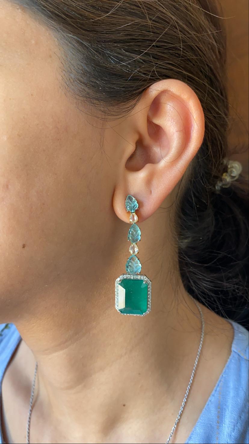 A gorgeous and modern earrings set in 18k yellow and white gold with natural cut and carved emeralds and full-cut and rose-cut natural diamonds. The emerald cut pair weight is 19.47 carats , emerald leaves weight is 6.62 carats, diamond combined