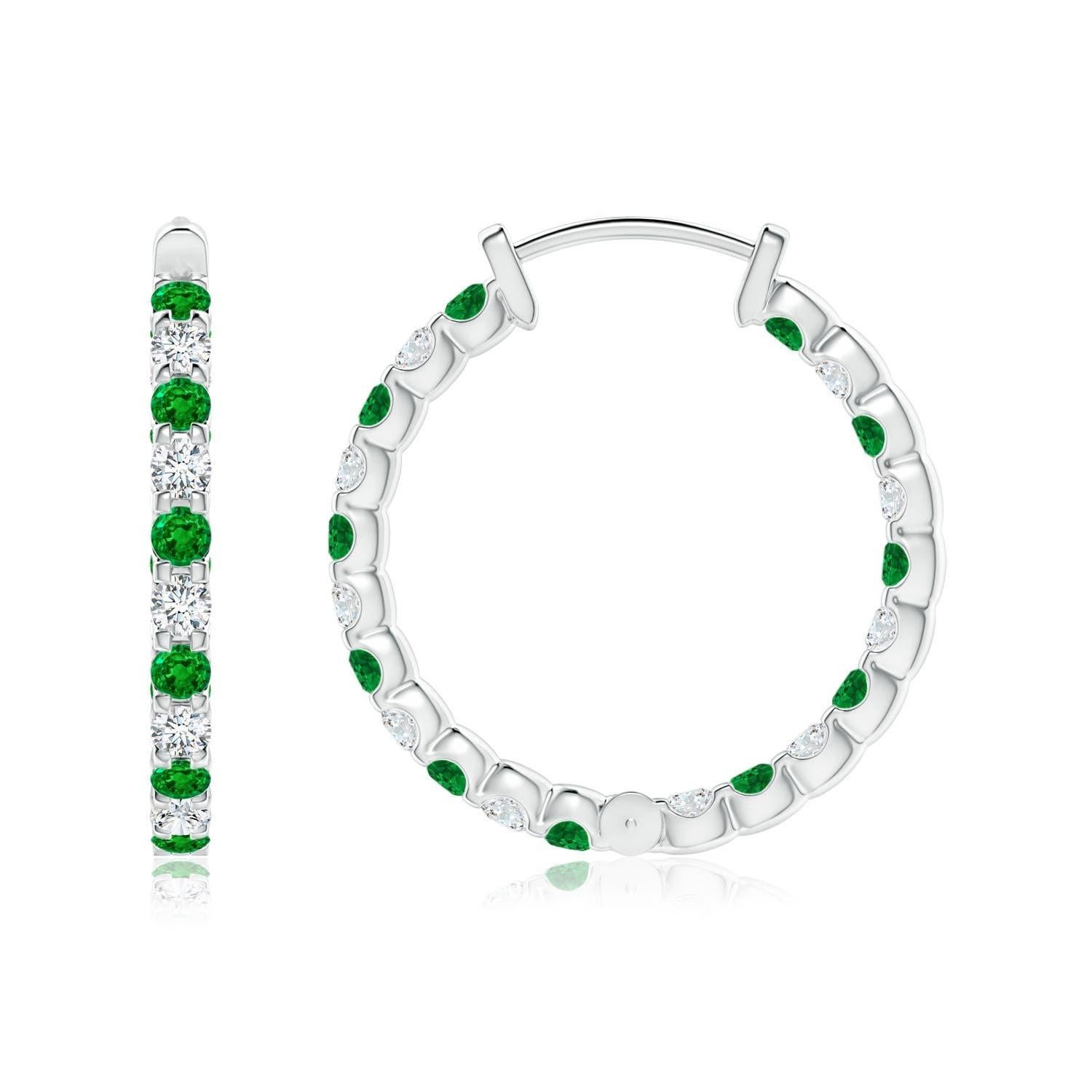 Alternately secured in prong settings are lush green emeralds and brilliant diamonds on these stunning hoop earrings. The scintillating gems are embellished on the outside as well as the inside of these 14k white gold hoops, showcasing a striking