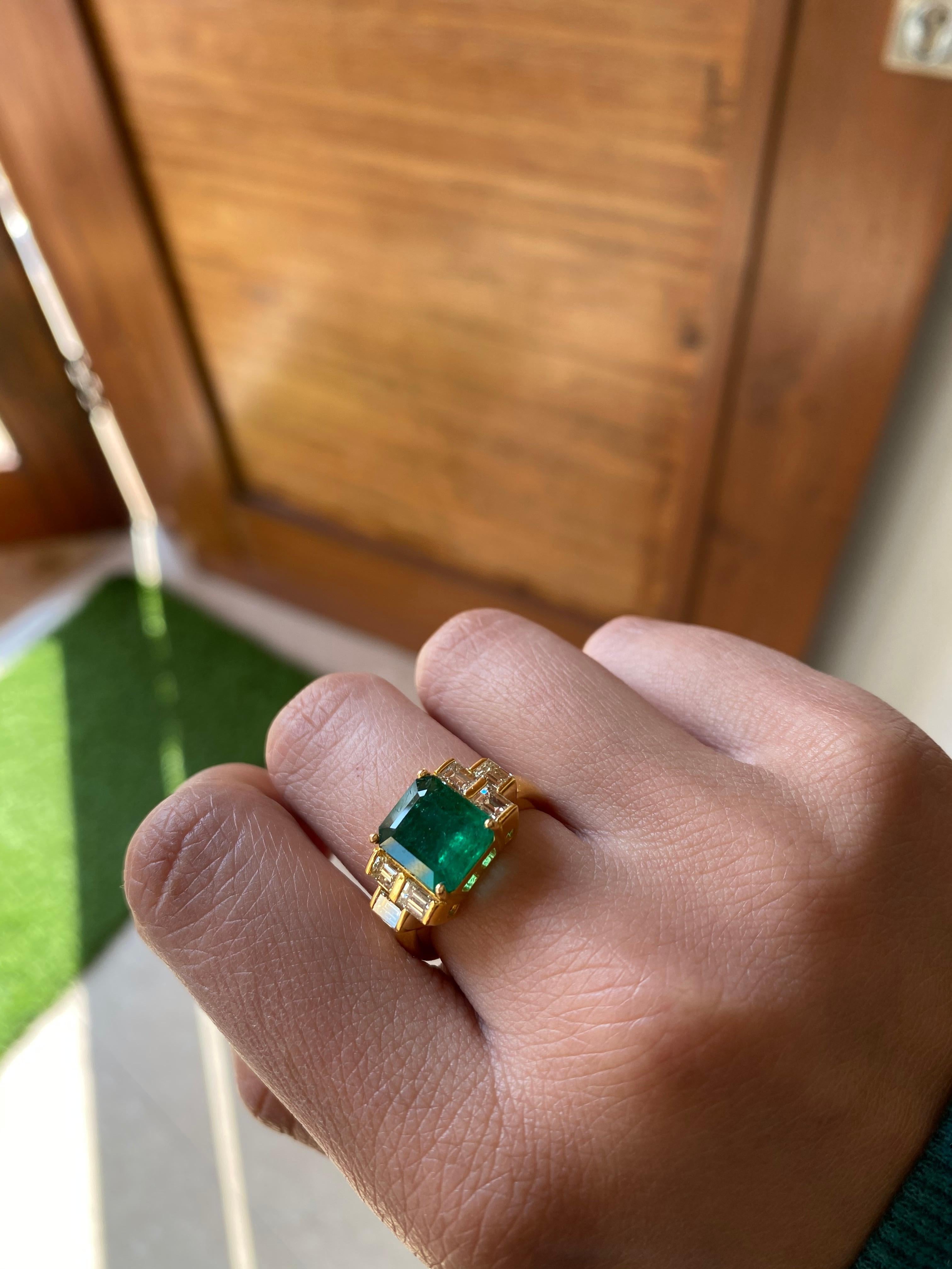 A beautiful and simple natural emerald and diamond ring set in 18k yellow gold. The natural emerald weight is 3.25 carats and natural diamond weight is .95 carats. The net gold weight of the ring is 6.002 grams and ring dimensions in cm 1 x 2 x 2.3