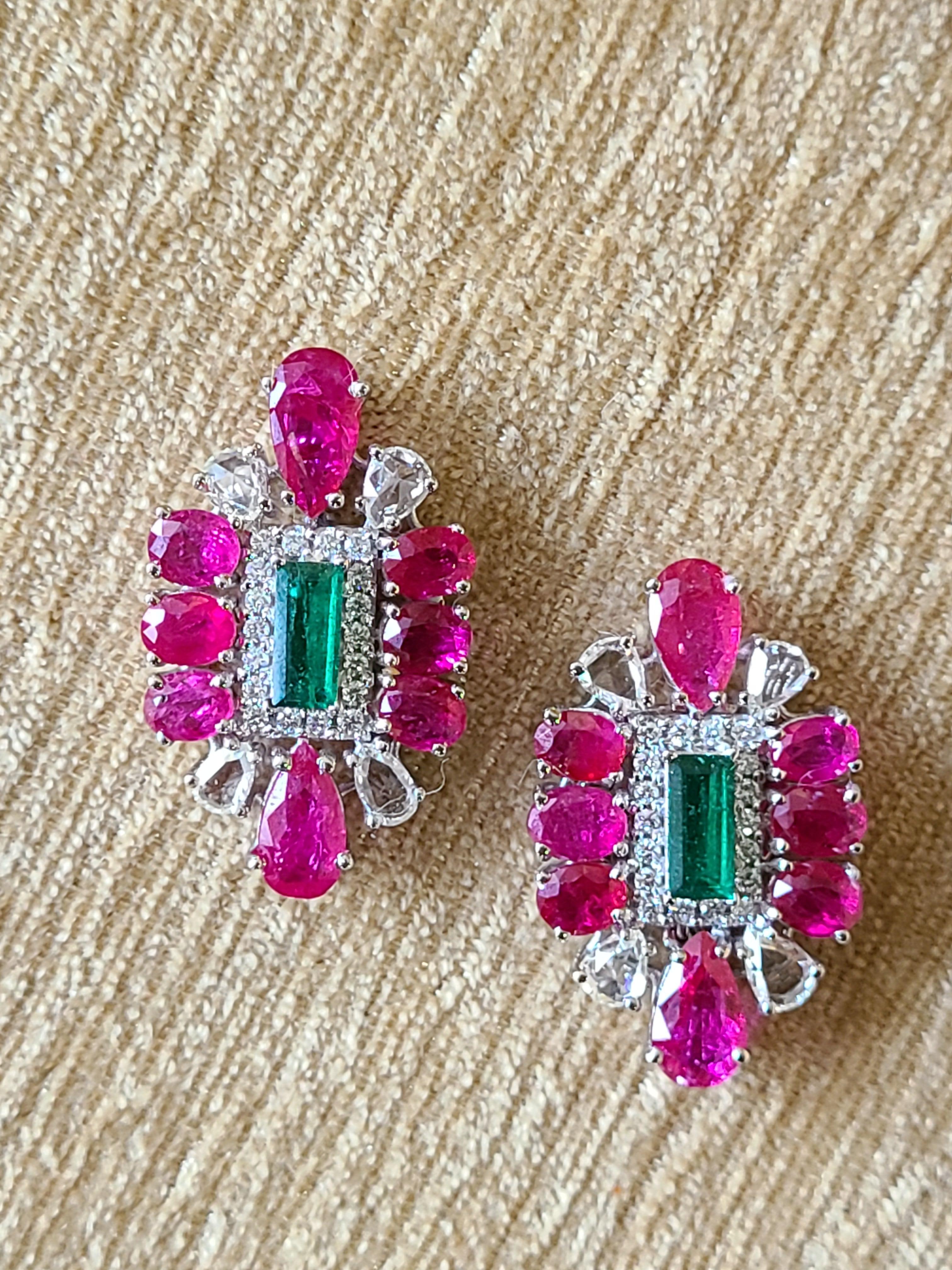A gorgeous and modern ruby, emerald and diamond earrings convertible to studs in 18k white gold. The emerald weight is .91 carats and natural ruby weight is 5.1 carats. The diamond weight is 1.52 carats and net gold weight is 9.664 and earrings