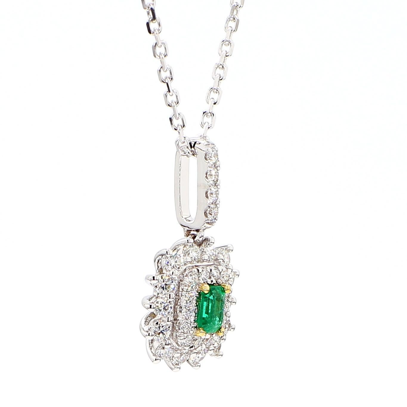 RareGemWorld's beautiful emerald pendant. Mounted in a beautiful 18K White Gold setting with a natural emerald cut emerald surrounded by natural round white diamond melee. This pendant is guaranteed to impress and enhance your personal