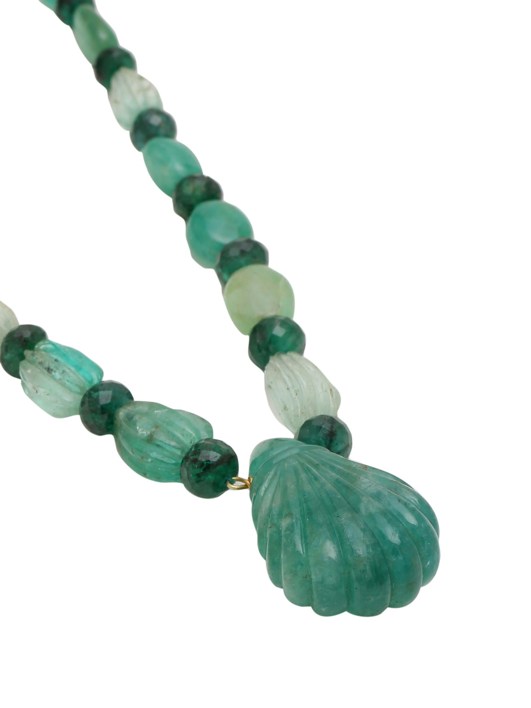 Different shades of natural Emerald carefully selected and strung together to form this exquisite necklace. The Emeralds are hand carved and some are Facetted. The big Carved drop centre weighs 55.51 carats on its own. The Emeralds are all natural.