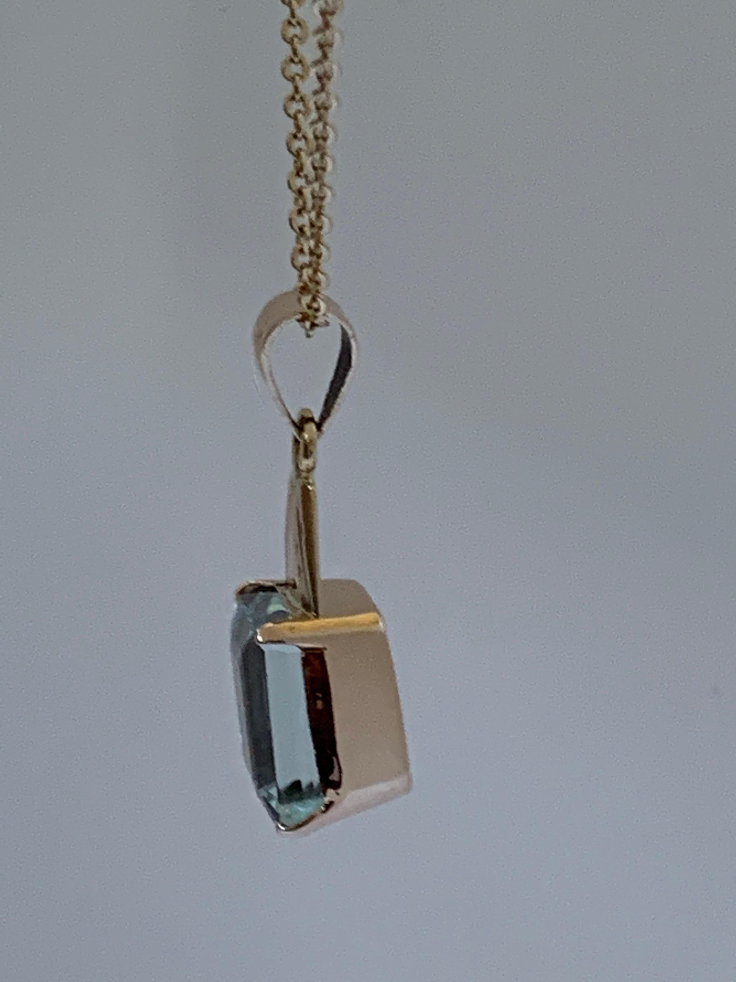 Natural Rectangular Aquamarine is 8 mm X 10 mm set in 14 Karat Yellow Gold is one of a kind handcrafted Pendant. The stone also hand cut and polished. 