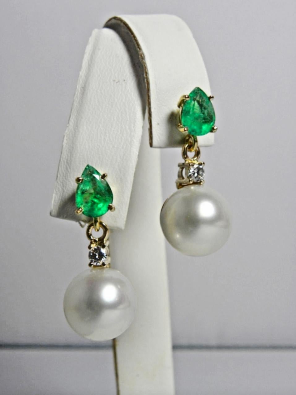Stunning Natural Colombian Emerald Diamond and Pearl Drop Dangle Earrings 18K
100% Natural Colombian Emeralds (Minor Oiled) Pear Cut  AAA Medium Green/ Clarity, VS/SI 
Total Emeralds Weight: 2.24 Carats (2 Emeralds)
Emeralds Measurements:  Approx.