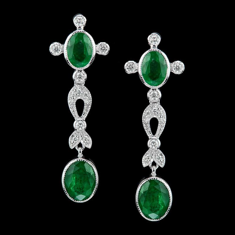 4 pieces of charming emerald matching is proper for this Art Deco style.
These earrings are very luxurious, you could wear them for a special occasion.

Earrings were made in 18K White Gold. 
Natural Emerald 4 pcs. (Oval 8x6, Oval 9x7) 6.24
