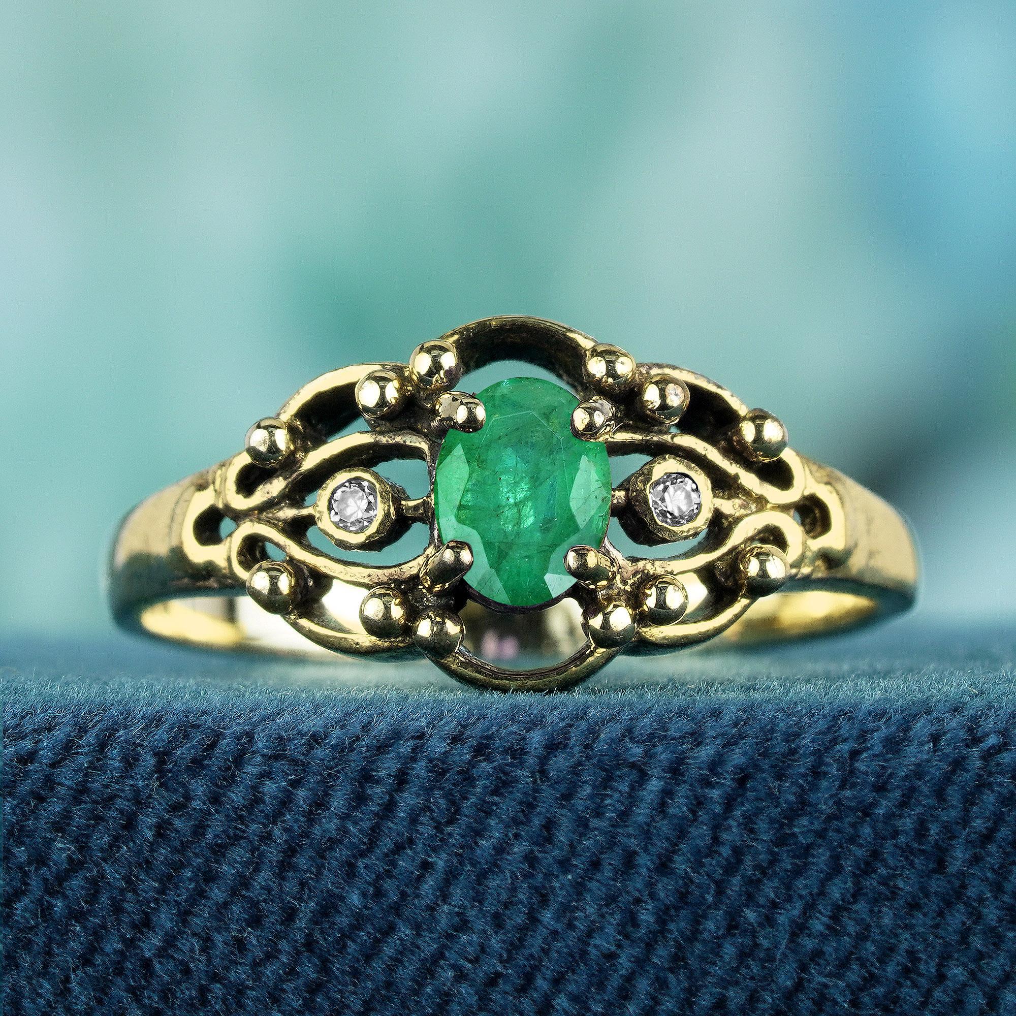 Voici la bague de fiançailles de style vintage en or jaune 9 carats, ornée d'une émeraude naturelle et d'un diamant, une pièce qui allie harmonieusement l'élégance et le charme intemporel. Cette bague exquise présente une captivante émeraude sertie