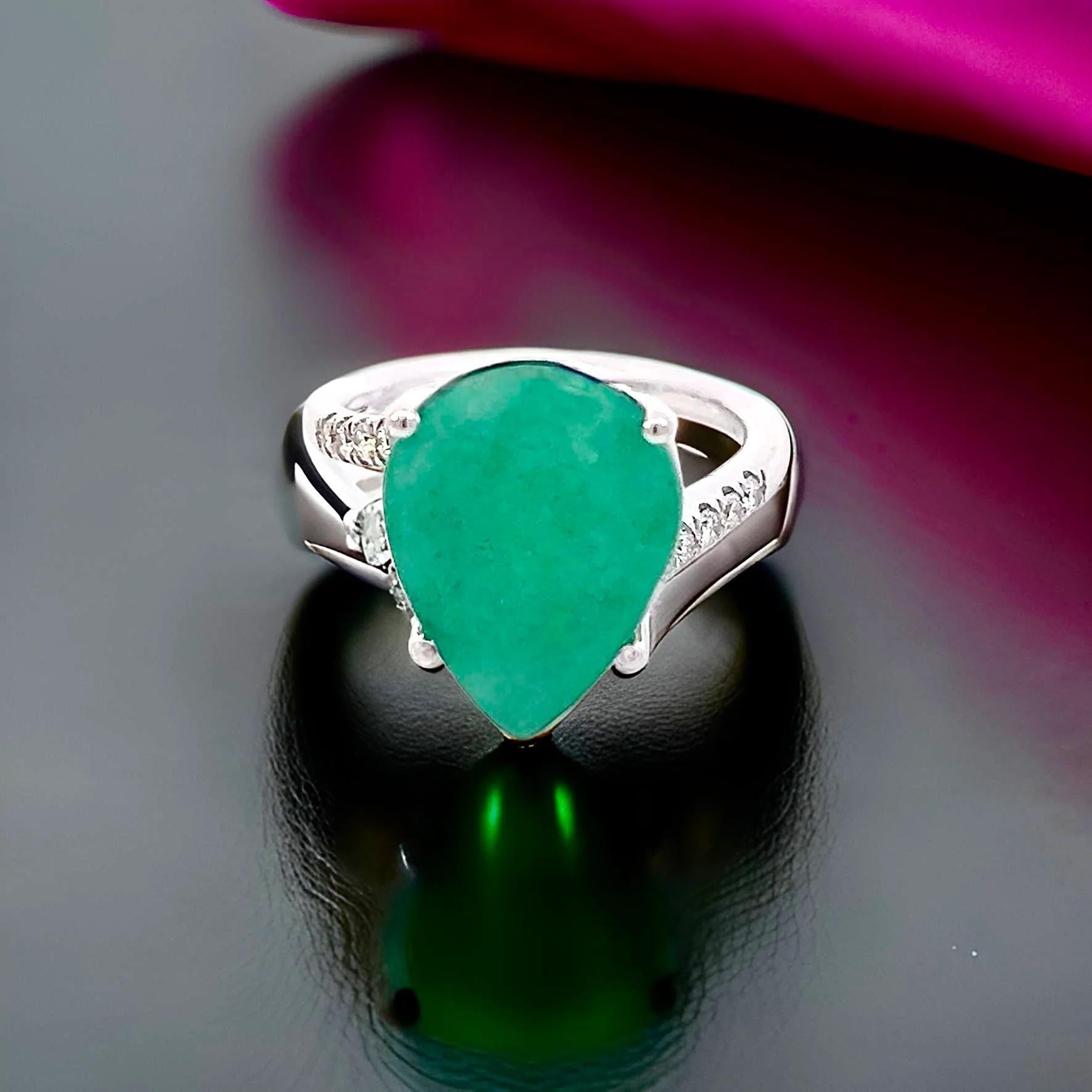 Natural Finely Faceted Quality Emerald and Diamond Ring Size 7 and resizable and set in 14k White Gold with a total ct weight of 7.17 TCW
Certified $4,975 401576
 
This is a Unique Custom Made Glamorous Piece of Jewelry!
 

This stunning natural
