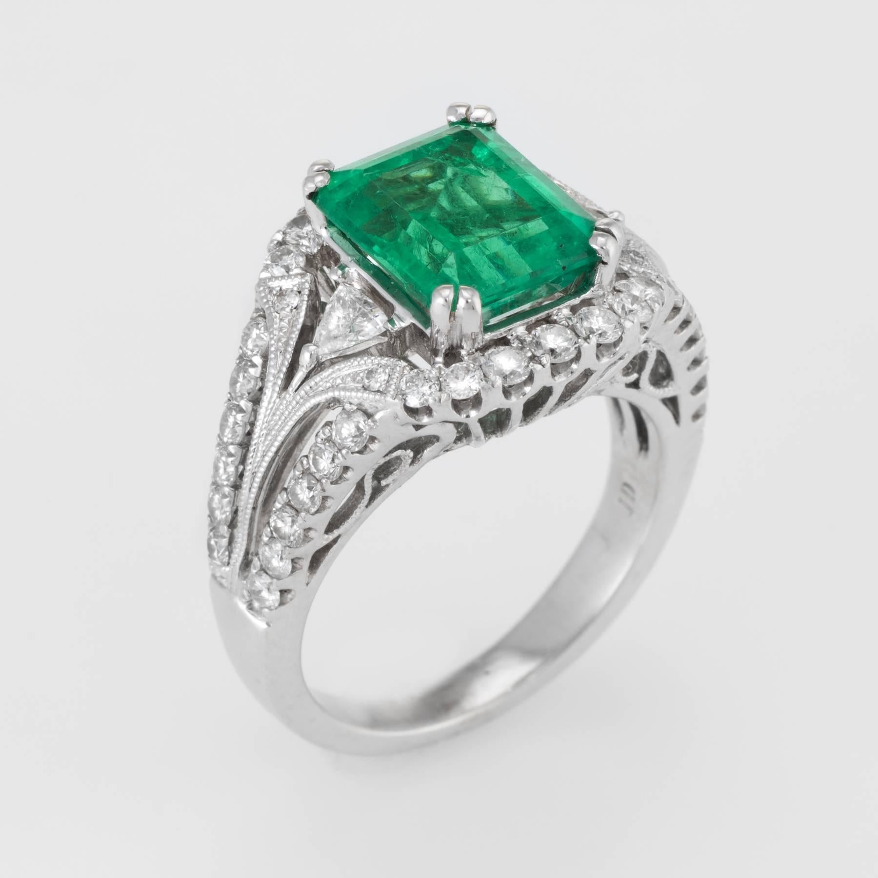 Elegant vintage cocktail ring (circa 1980s), crafted in 18 karat white gold. 

Centrally mounted emerald cut natural emerald measures 9.5mm x 8mm (estimated at 2.75 carats), accented with an estimated 1.20 carats of diamonds (estimated at H-I color