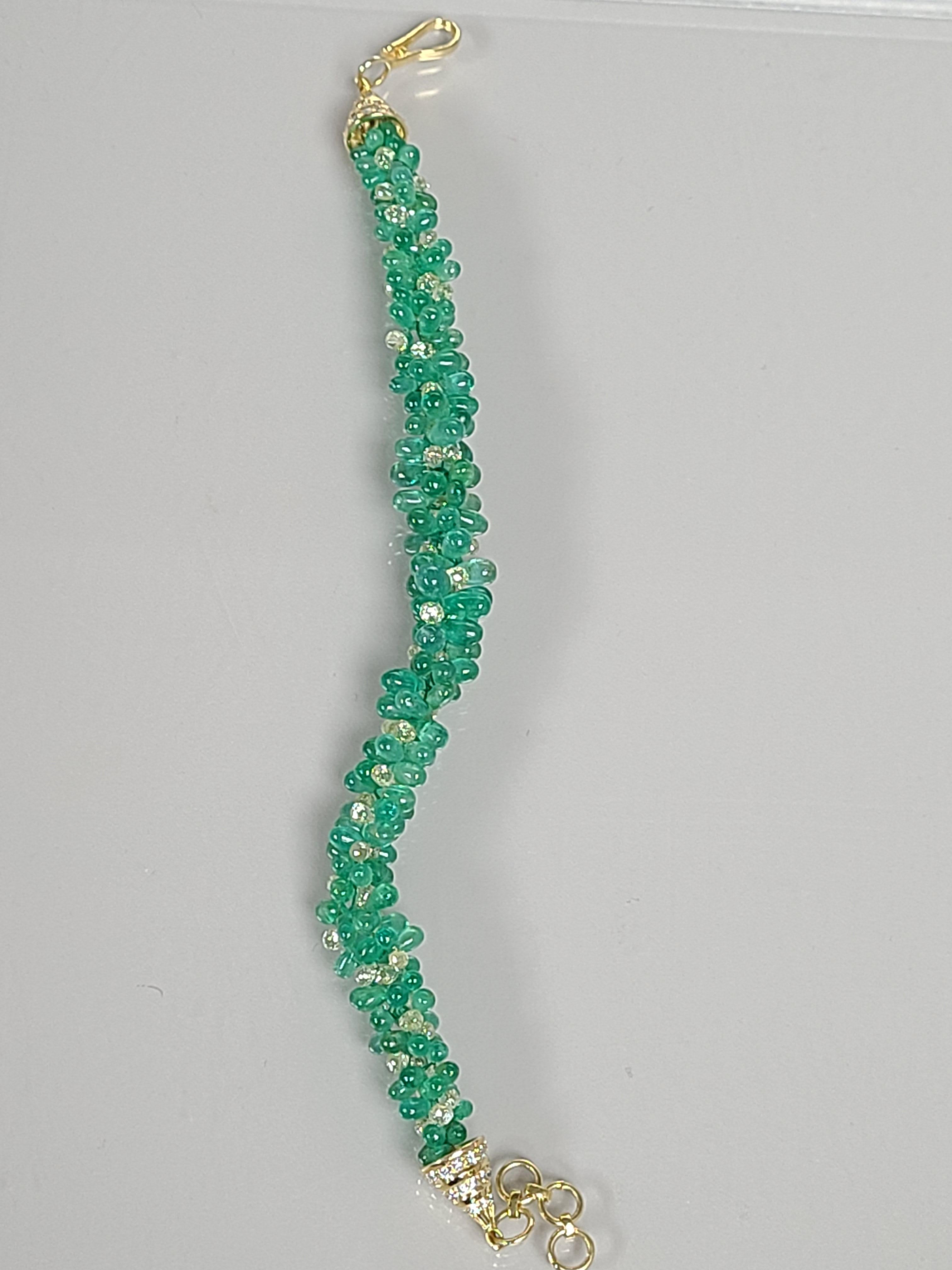 A beautiful and Unique Emerald bracelet with diamond round and diamond briolette in 18k gold. The emerald weight in the bracelet is 52.22 carats and combined diamond weight is 13.30 carats. The length of the bracelet in inch is 6.75.