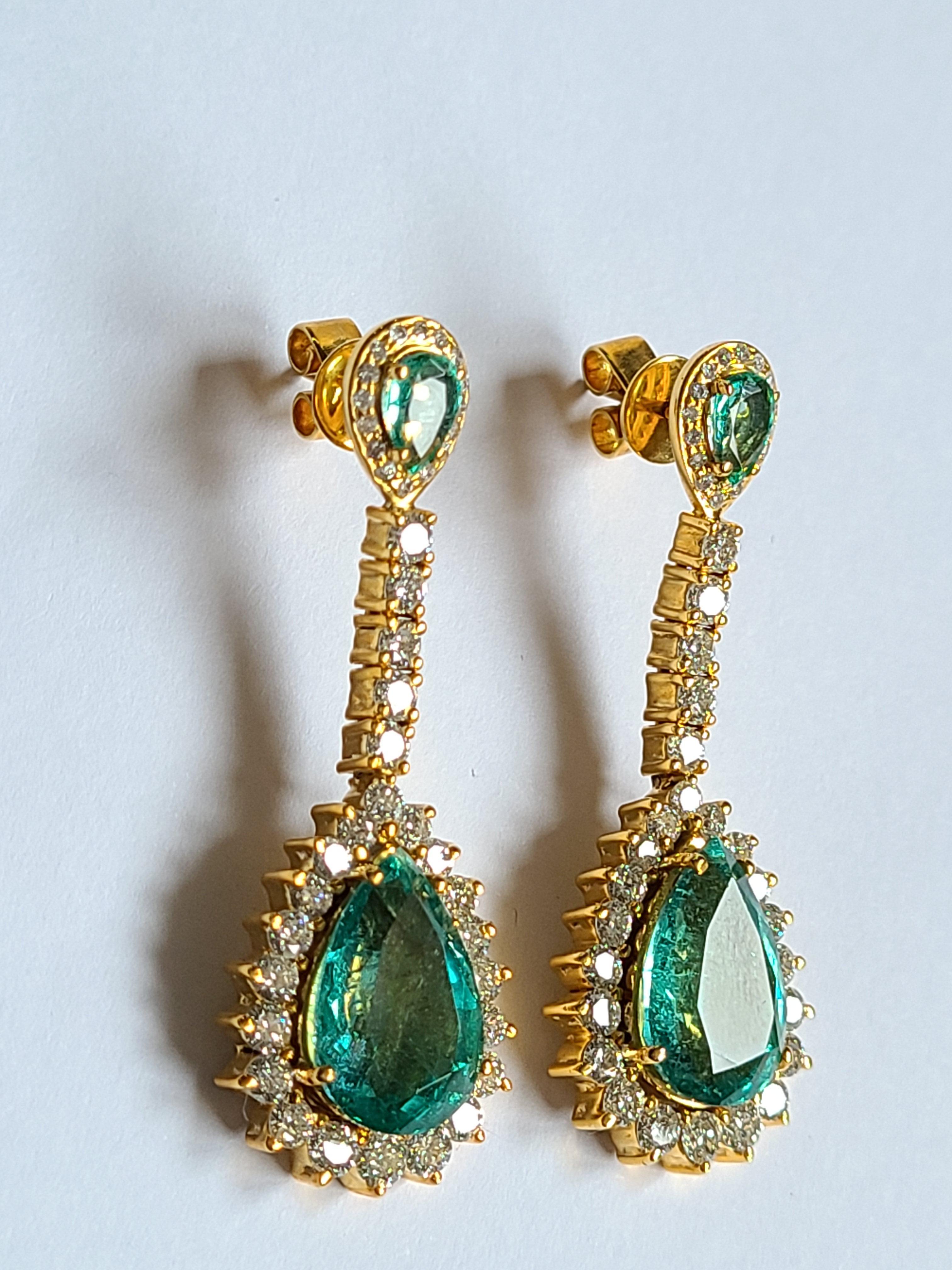 A classic design emerald earrings set in 18k gold with diamonds. The emerald weight is 8.78 carats and diamond weight is 2.72 carats . The earrings dimensions in cm 4.2 x 1.4 x .06 (LXWXD).