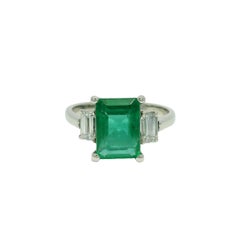 Nature Emerald & Emerald Cut Diamond Side Stone Platinum Ring In Stock