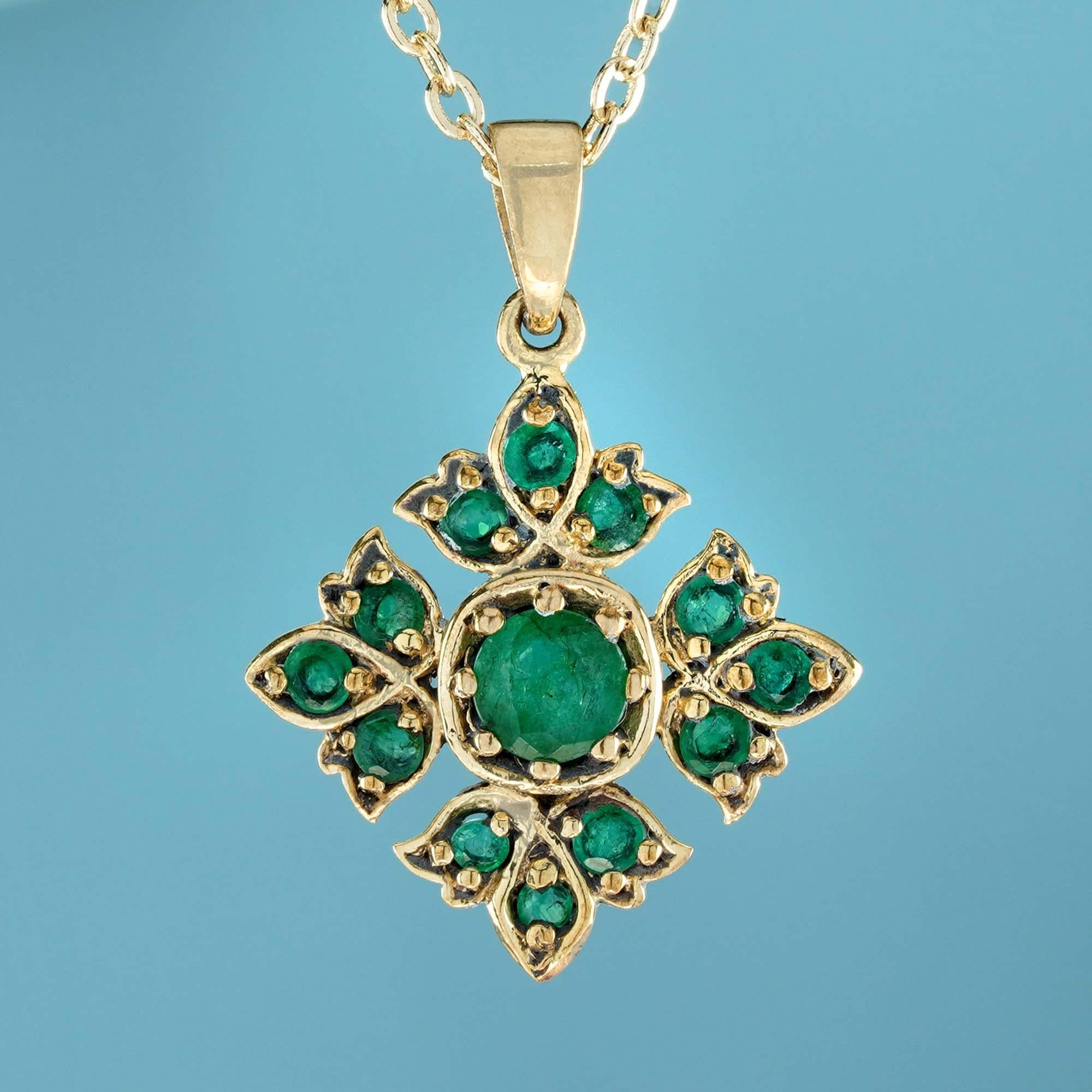 The pendant showcases clusters of four petal-shaped designs, with each petal crafted from vibrant round emeralds set in both round and marquise-shaped frames. These petals surround the central point of the flower, secured in a prong setting. The
