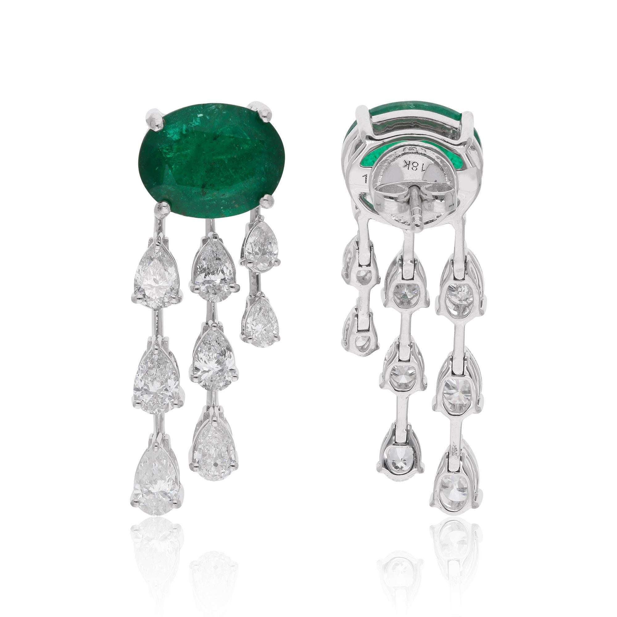 Step into a world of timeless elegance with these enchanting natural emerald gemstone earrings, adorned with pear-shaped diamonds and crafted from exquisite 14 karat white gold. Radiating with sophistication and grace, these earrings are a true