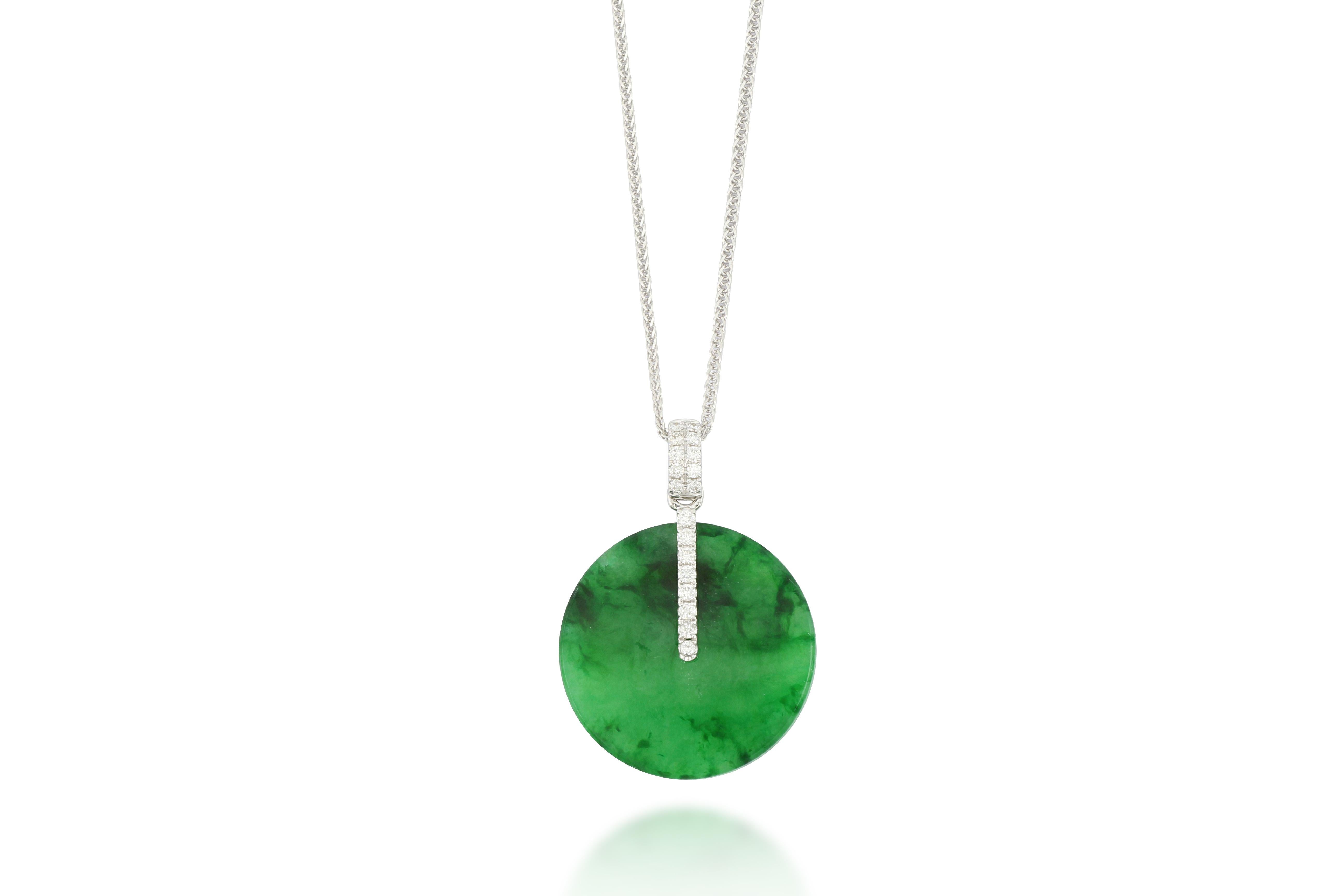 A translucent emerald green natural jadeite pendant in perfect round shape, decorated with round brilliant-cut diamonds, weighing 0.19 carats in total, mounted in 18 karat white gold. 

The company was founded one and a half centuries ago in Macau.