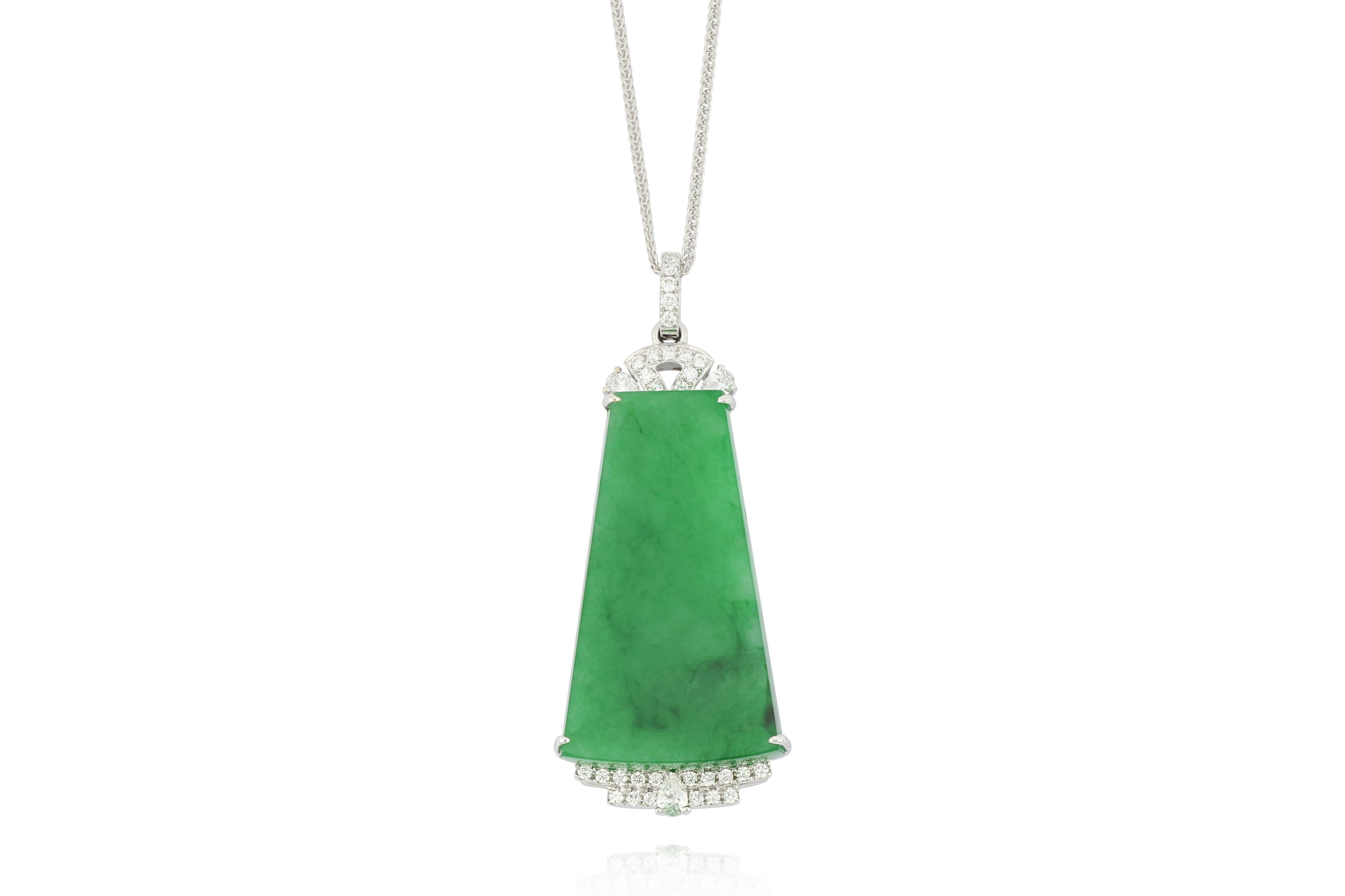 A highly translucent emerald green natural jadeite pendant in the shape of trapezium, decorated with round brilliant-cut diamonds, weighing 0.43 carats in total, mounted in 18 karat white gold. Accompanied by report number FC06777 dated August 29,