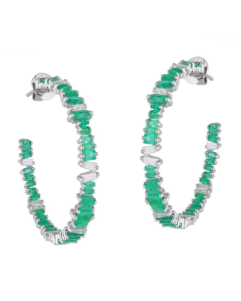 Modern and innovative,  Ivy Emerald Hoop Earrings symbolize strength and freedom. Handcrafted in our workshops, it has a combination of a luxuriant style enhanced with very fine materials like 18k gold and 1.60 cts diamond to bring out the