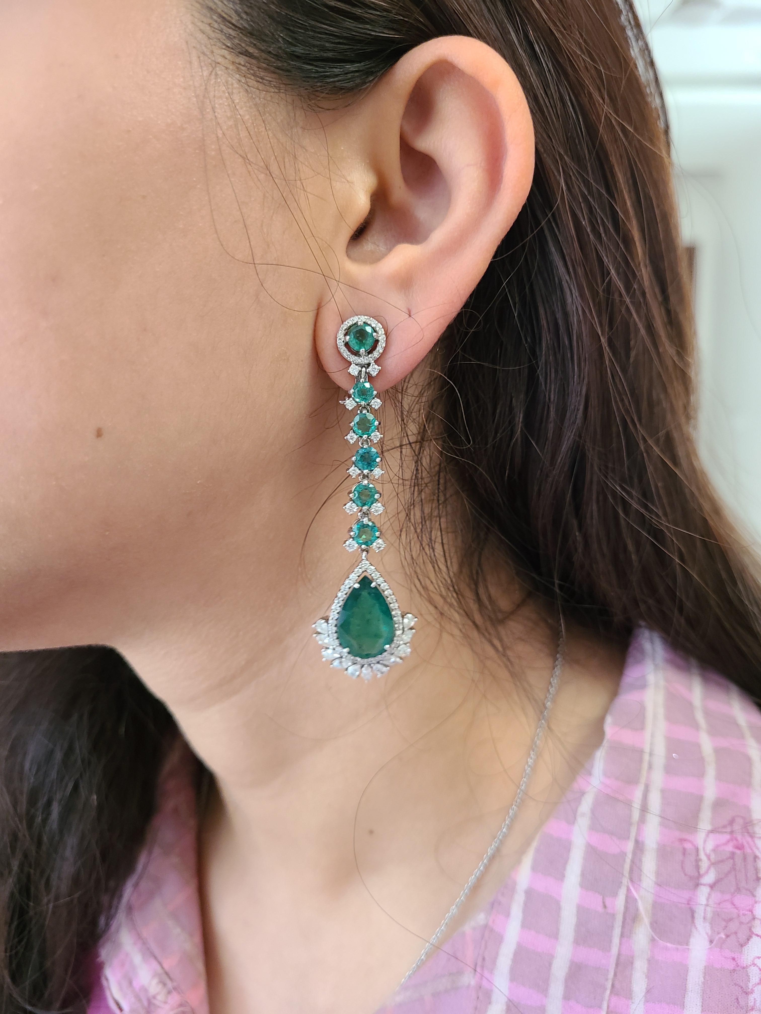 A beautiful set of natural emerald earrings with diamond set in 18k white gold . The emeralds are natural from Zambia with combined weight of 16.34 carats and diamond weight is 2.78 carats. The net gold weight is 16.08 grams and earrings dimension