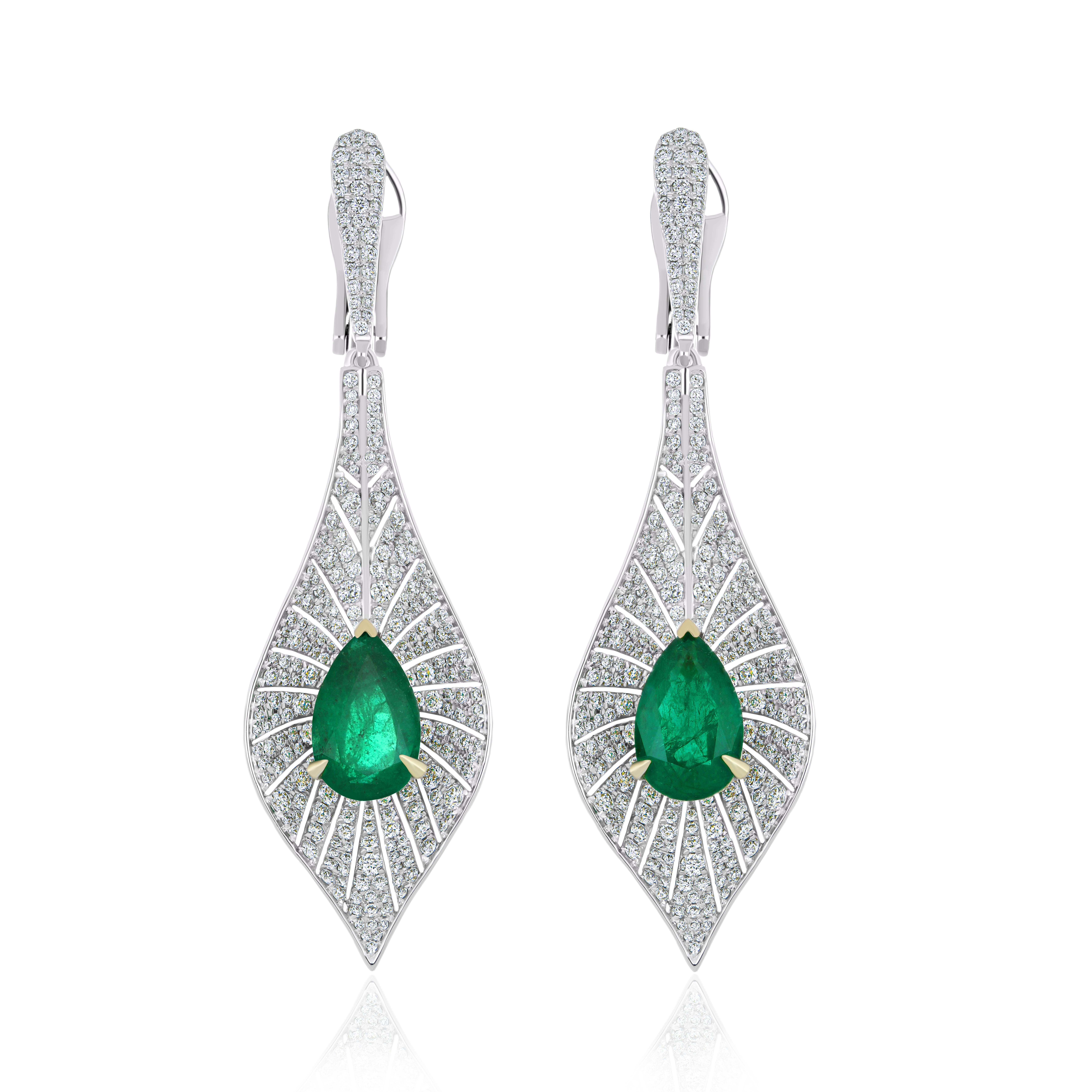 Elegant and Exquisitely detailed White Gold earrings, with 6.2 CT's (total approx.) Emerald Pear Shape, accented with micro pave Diamonds, weighing approx.  3.05 CT's. (total approx.). total carat weight. Beautifully Hand-Crafted Earring in 18 Karat