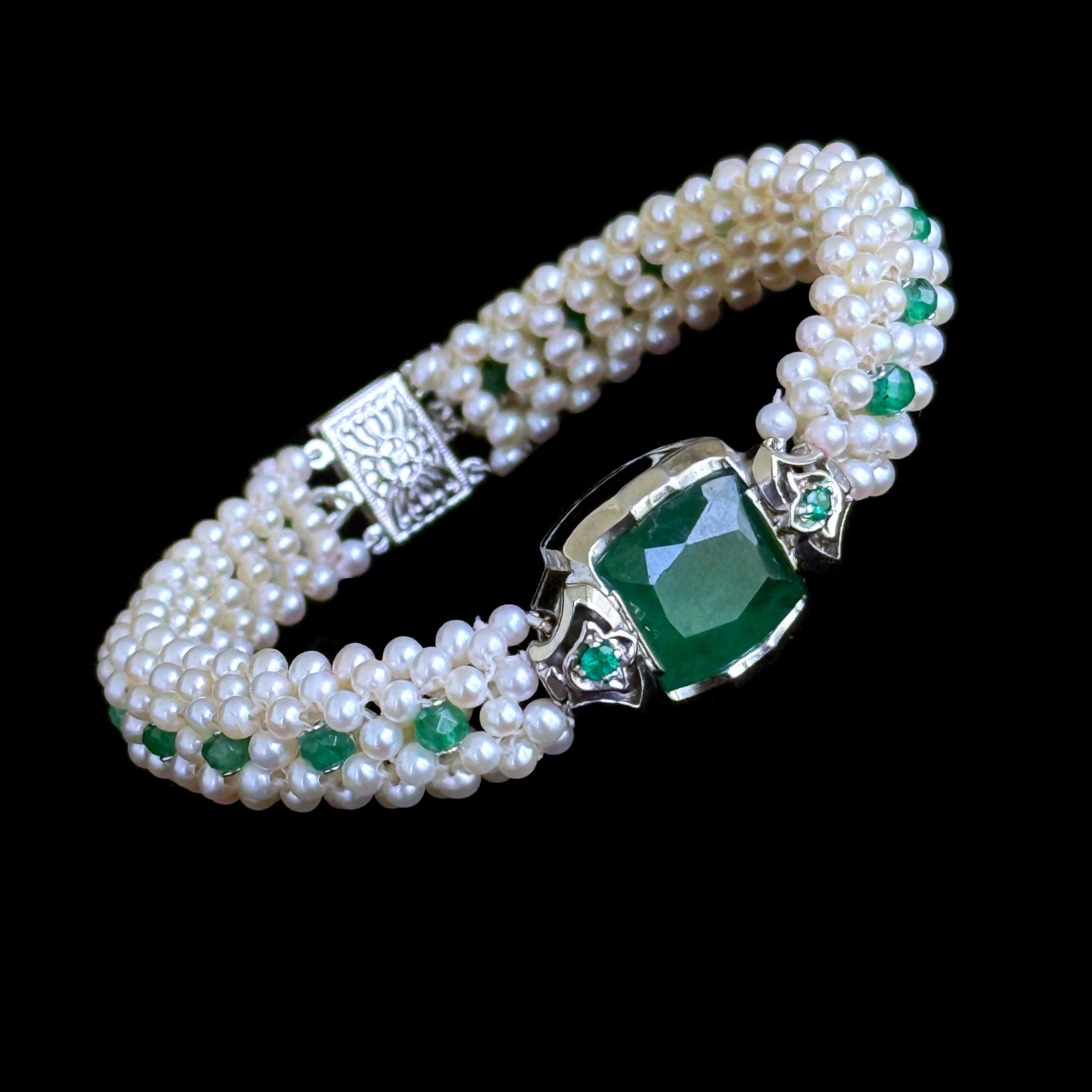 Gorgeous, regal and timeless.

Pearls are intricately woven together into a dome like band, woven flat on the bottom to sit comfortably on the wrist - and is entirely adored by Faceted natural Emeralds throughout. Measuring 6.75 inches long, this