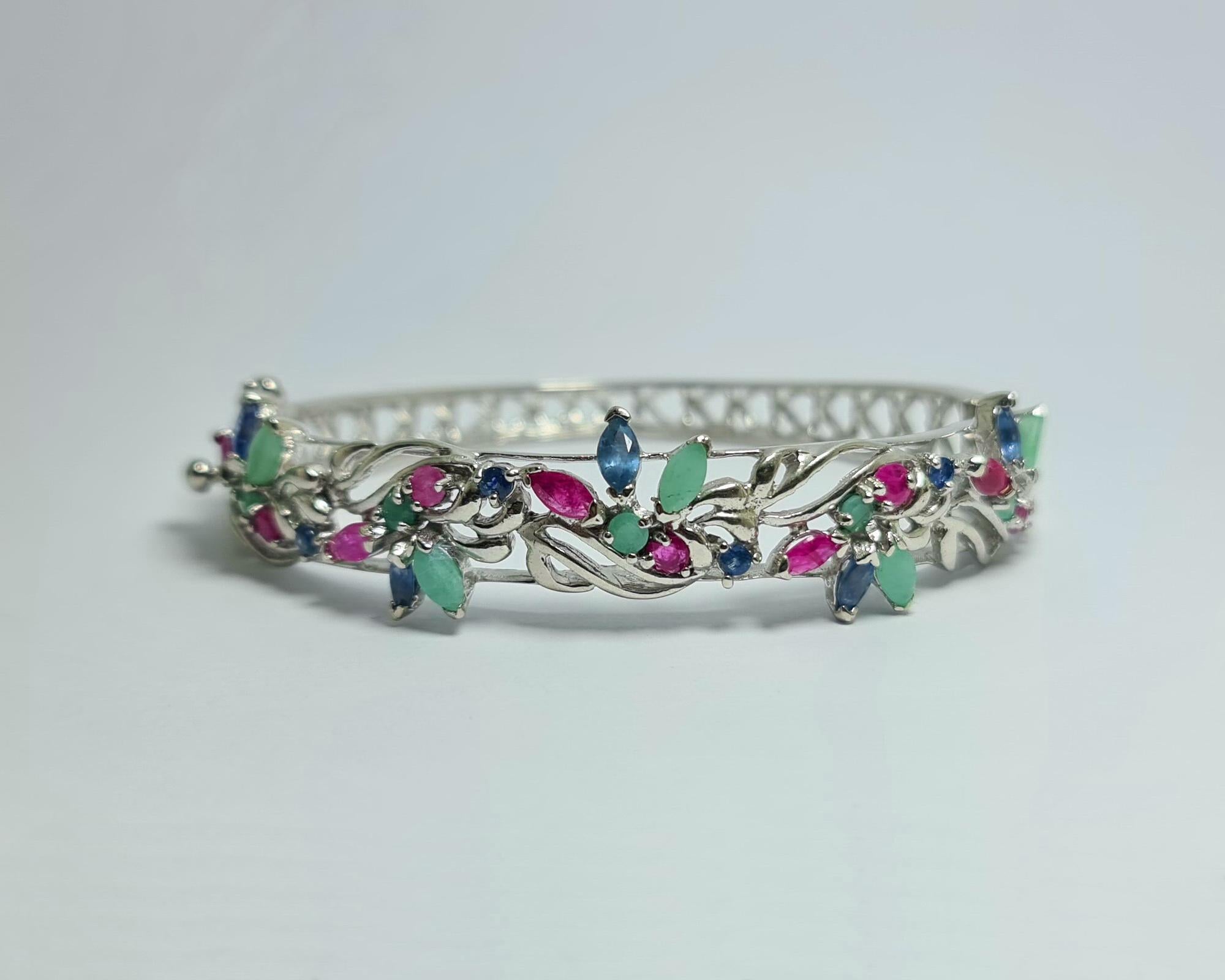 Natural Untreated Afghan Emerald and Thai Rubies and Sapphires  Marquis Oval and Round Cuts Set in Pure .925 Sterling Silver with Rhodium Plating Tutti Frutti Bangle Cuff Bracelet 

Total carats: 15 carats
Weigh of the bracelet 28 grams