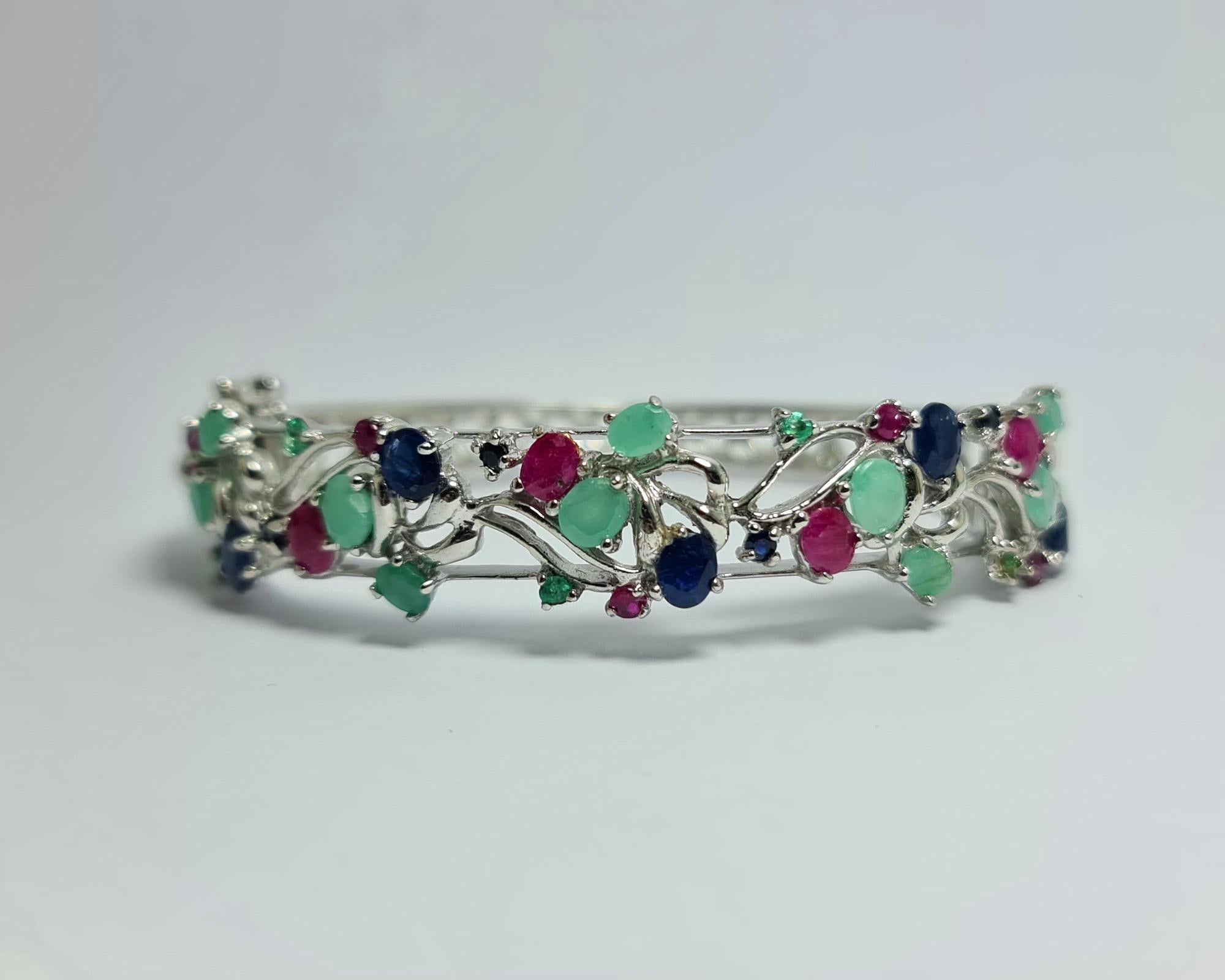 Natural Untreated Afghan Emeralds  and Thailand Rubies and Sapphires  Tutti Frutti set in Pure Sterling Silver with Rhodium Plated Hinged Bracelet Cuff Bangle 

Total carats weight: 14 carats
Total weight of the bracelet: 28 grams