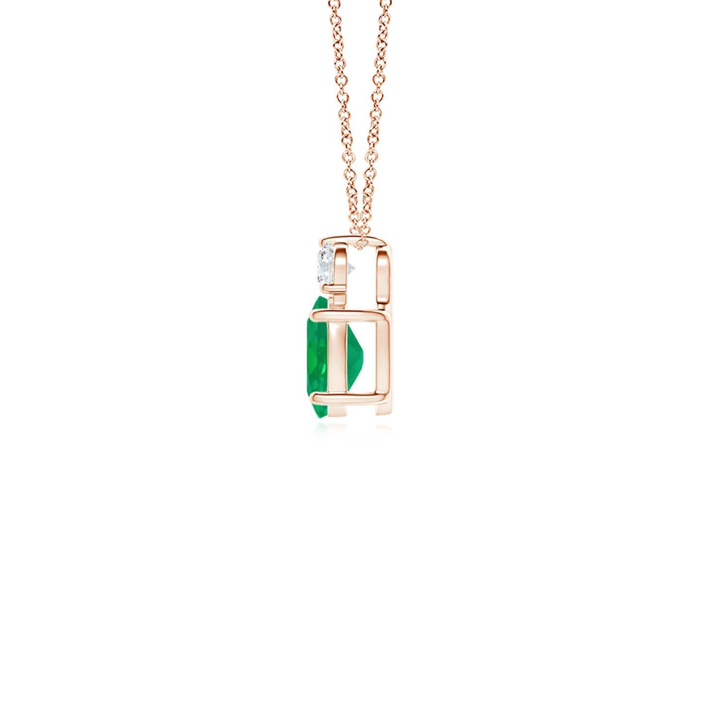 Crafted in 14k rose gold, this classic solitaire emerald pendant personifies elegance. The rich green oval emerald is topped by a sparkling diamond for added allure. The intricate scroll work on the sides enhances this prong set emerald pendant's
