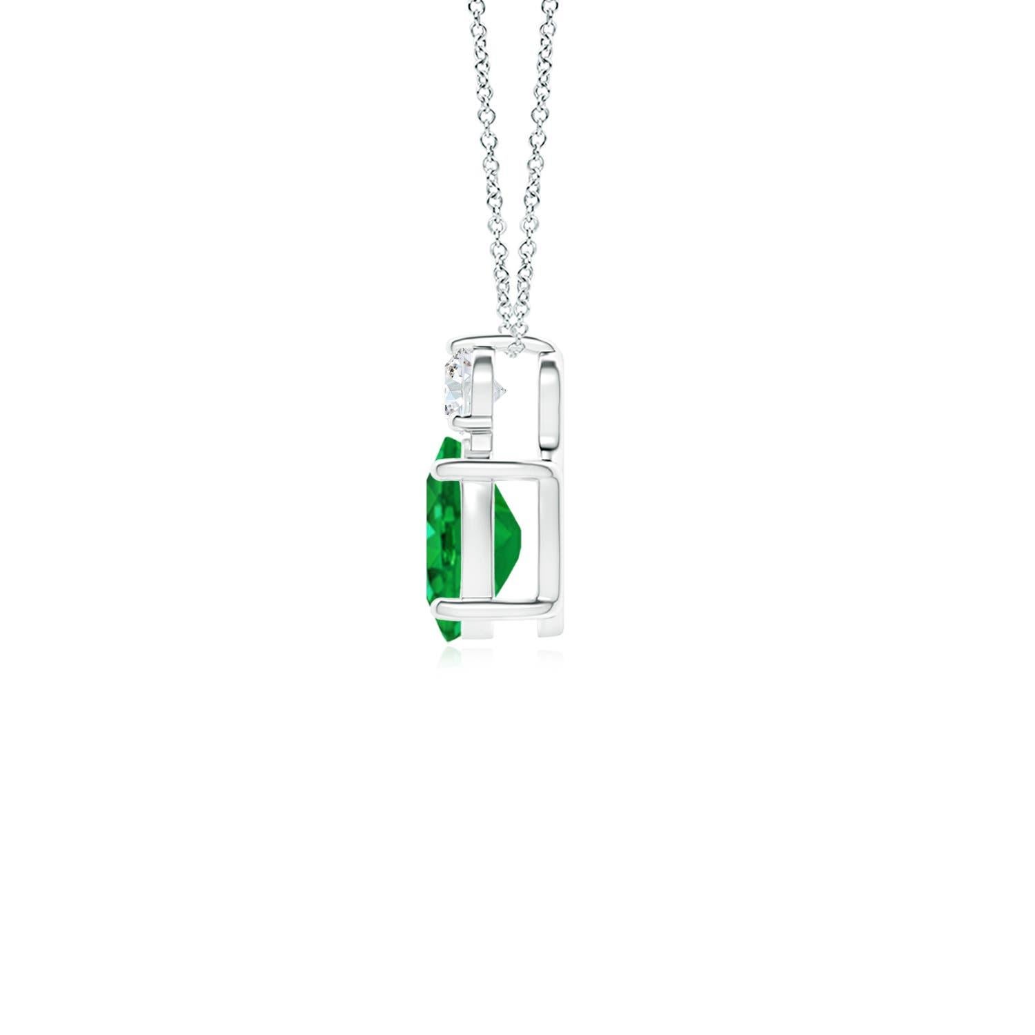 Crafted in 14k white gold, this classic solitaire emerald pendant personifies elegance. The rich green oval emerald is topped by a sparkling diamond for added allure. The intricate scroll work on the sides enhances this prong set emerald pendant's