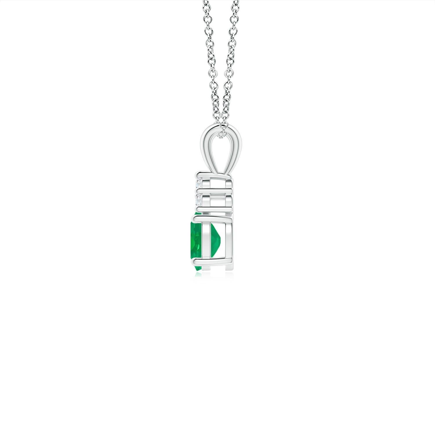 Set in platinum, this classic solitaire emerald pendant showcases the perfect blend of style and elegance. It features a lush green emerald adorned with three sparkling round diamonds on the top. Linked to a lustrous v-bale, this four-prong set