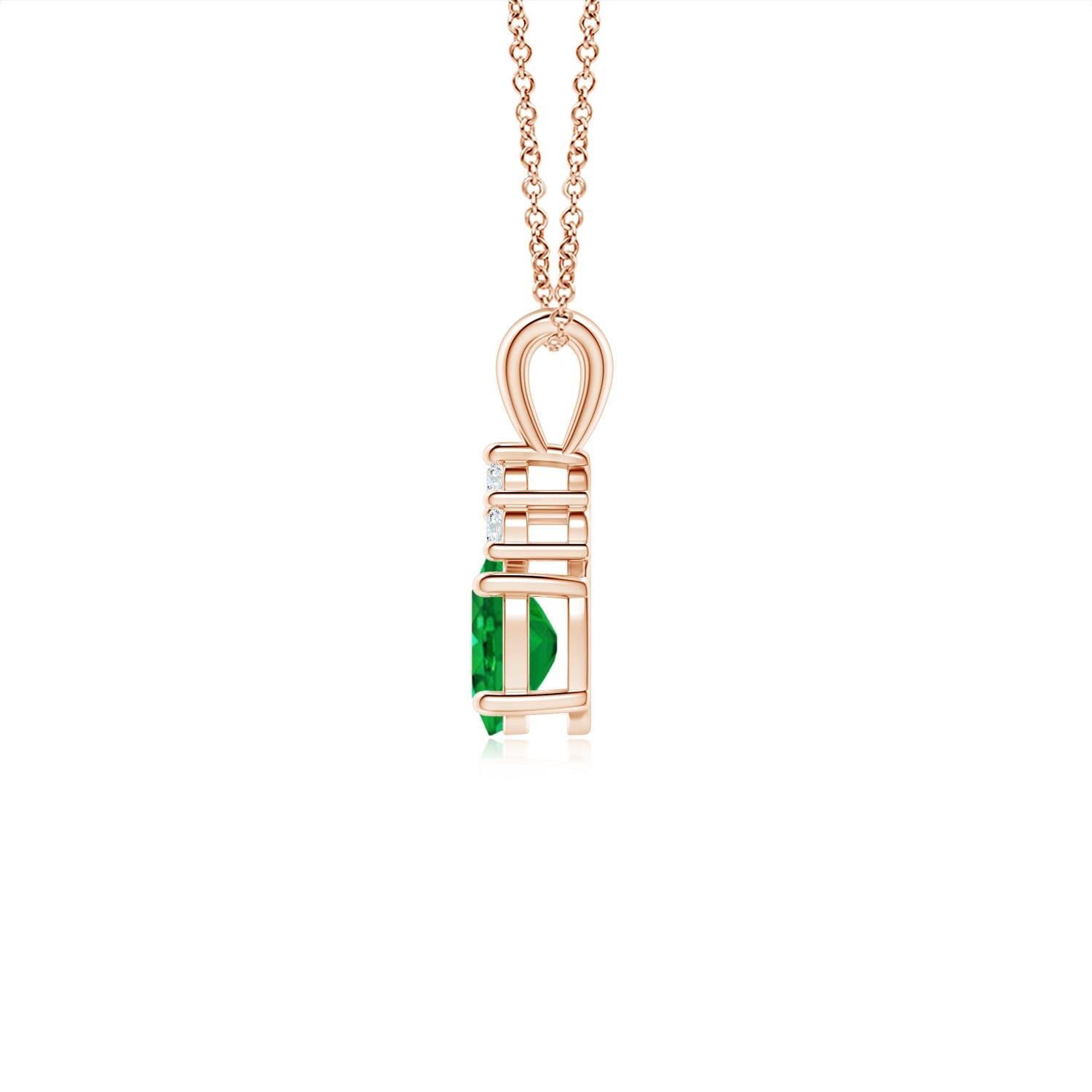 Set in 14k rose gold, this classic solitaire emerald pendant showcases the perfect blend of style and elegance. It features a lush green emerald adorned with three sparkling round diamonds on the top. Linked to a lustrous v-bale, this four-prong set