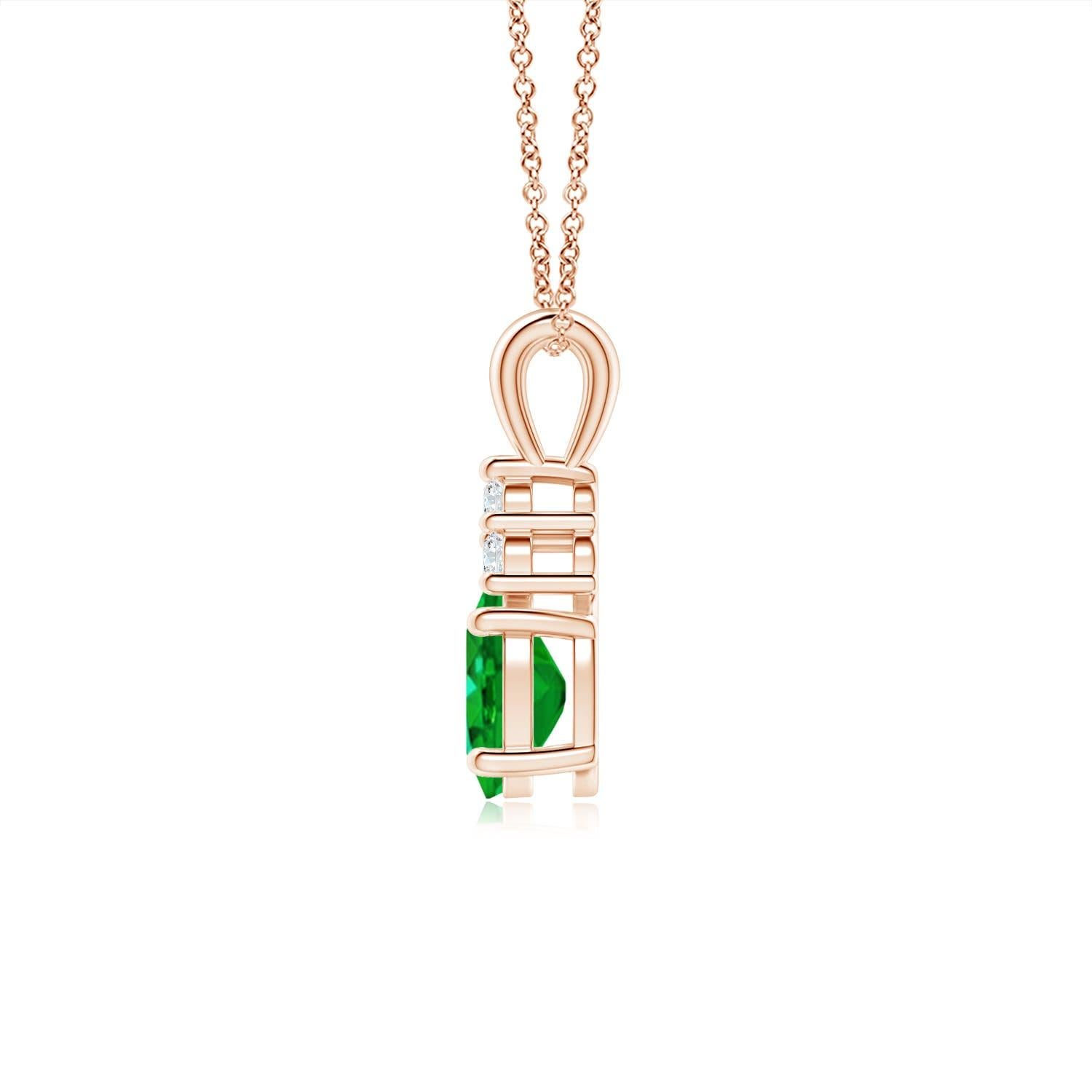 Set in 14k rose gold, this classic solitaire emerald pendant showcases the perfect blend of style and elegance. It features a lush green emerald adorned with three sparkling round diamonds on the top. Linked to a lustrous v-bale, this four-prong set