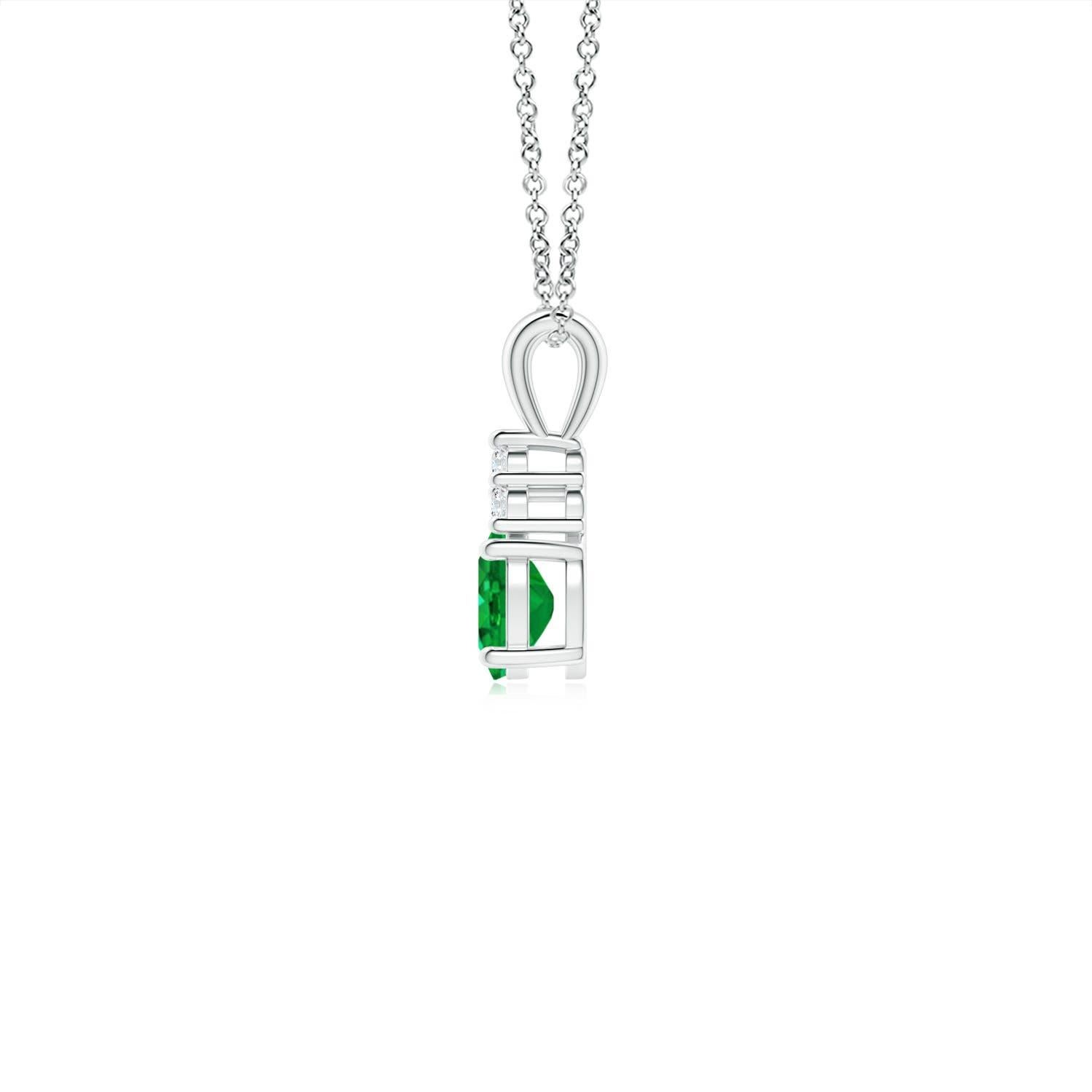 Set in 14k white gold, this classic solitaire emerald pendant showcases the perfect blend of style and elegance. It features a lush green emerald adorned with three sparkling round diamonds on the top. Linked to a lustrous v-bale, this four-prong