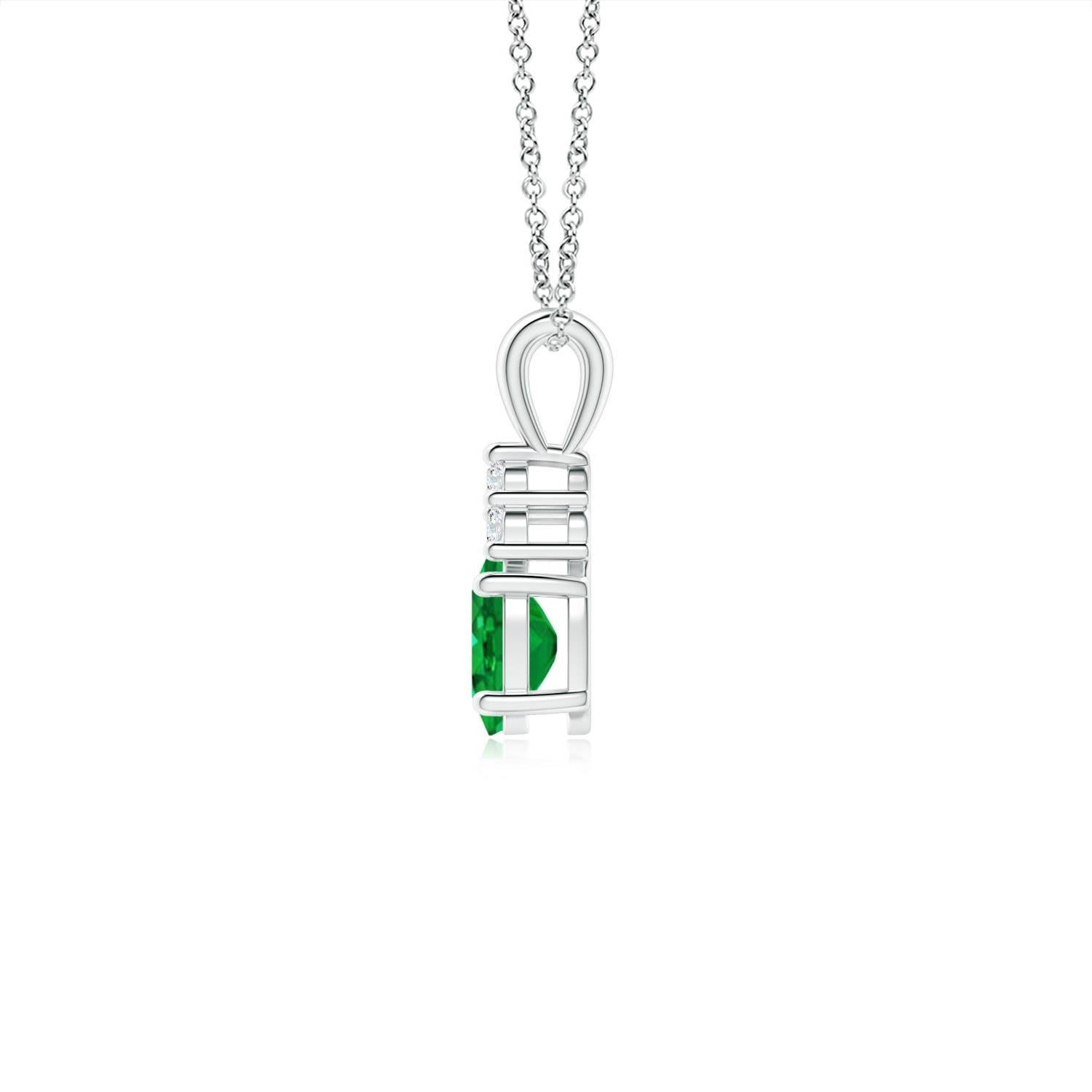 Set in 14k white gold, this classic solitaire emerald pendant showcases the perfect blend of style and elegance. It features a lush green emerald adorned with three sparkling round diamonds on the top. Linked to a lustrous v-bale, this four-prong
