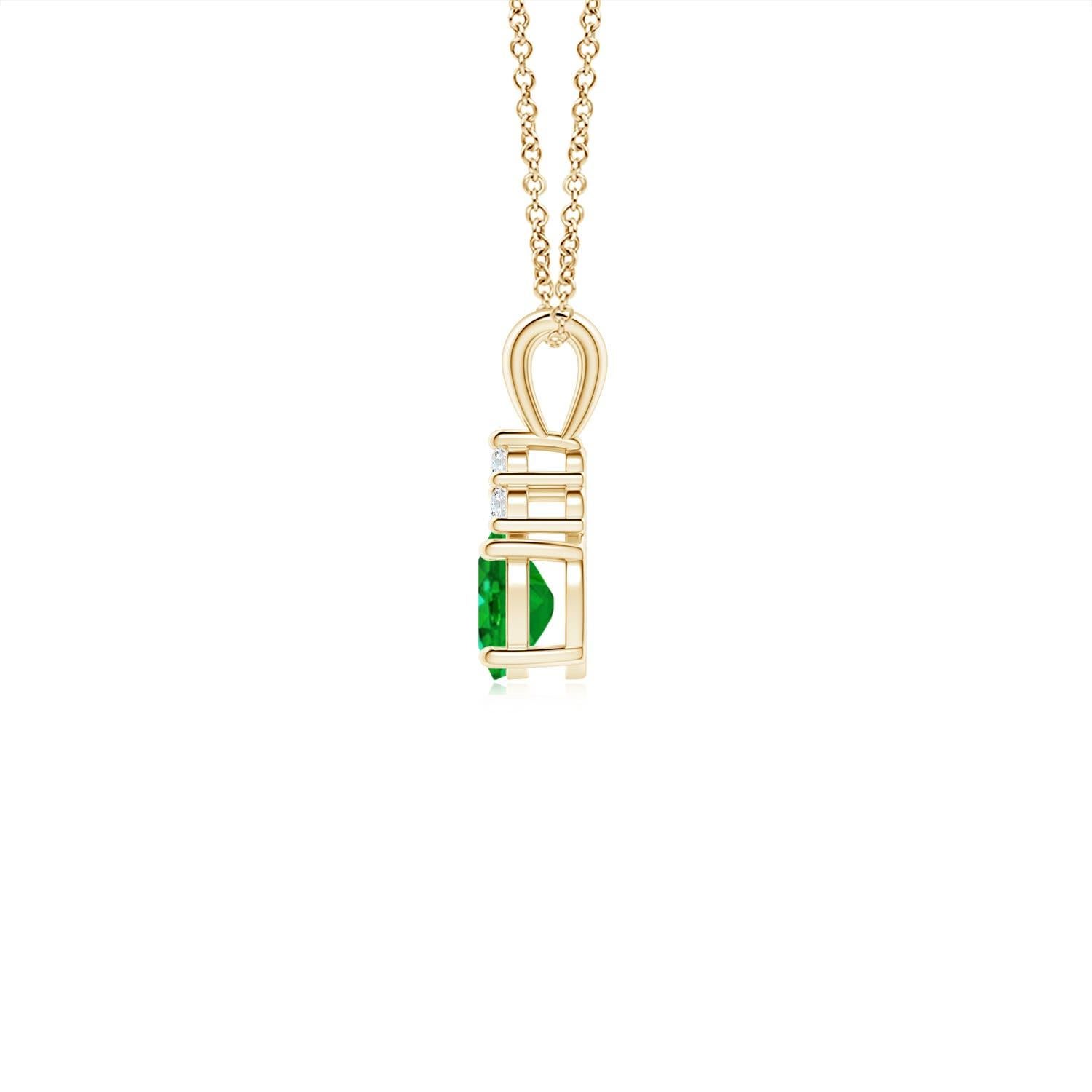 Set in 14k yellow gold, this classic solitaire emerald pendant showcases the perfect blend of style and elegance. It features a lush green emerald adorned with three sparkling round diamonds on the top. Linked to a lustrous v-bale, this four-prong