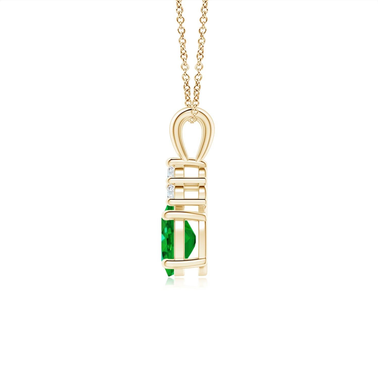 Set in 14k yellow gold, this classic solitaire emerald pendant showcases the perfect blend of style and elegance. It features a lush green emerald adorned with three sparkling round diamonds on the top. Linked to a lustrous v-bale, this four-prong
