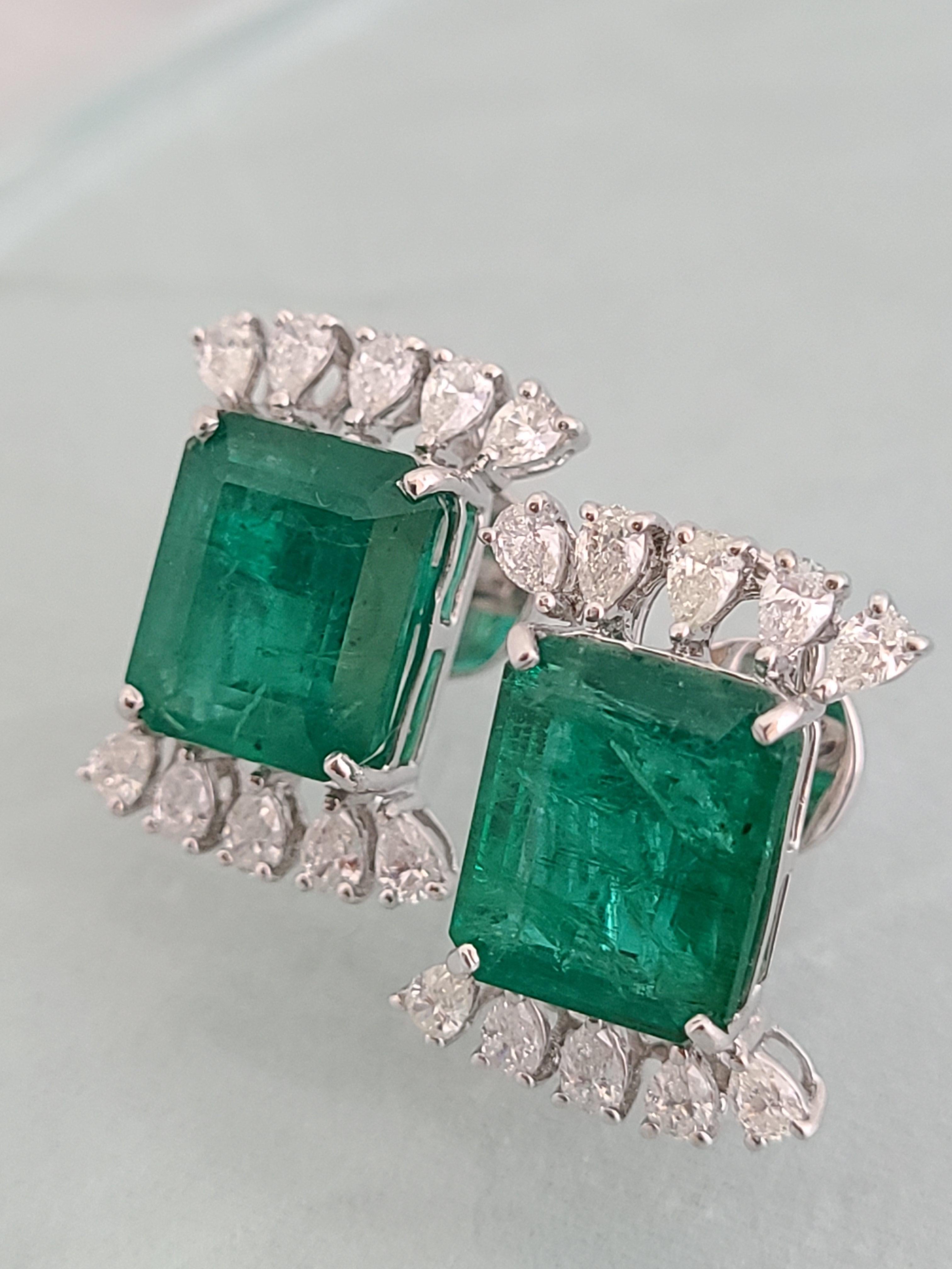 A pair of beautiful and stylish natural emerald studs in 18k white gold with diamonds. The emerald are natural from Zambia and weight is 14.24 carats with a diamond weight of 1.81 carats. The earrings dimensions in cm 2.2 x 1.6 x 2.2 (LXWXD).